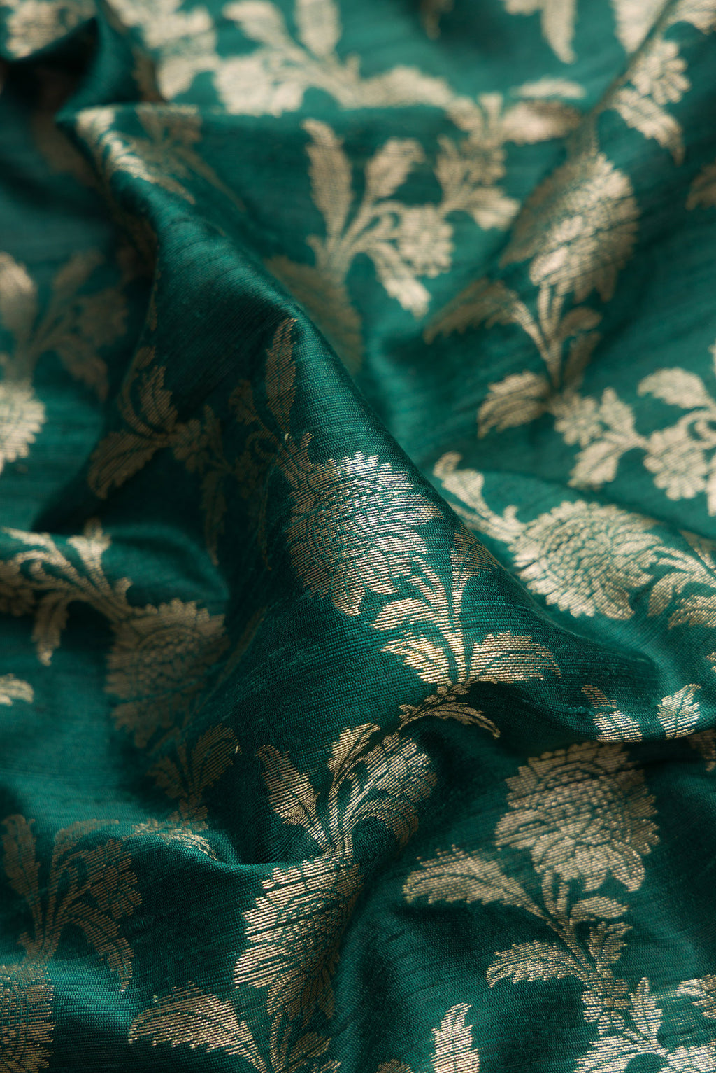 Close up of Bottle Green Dual Tone Banarasi Silk Saree with Zari Brocade on the body and Zari Border.  displaying folds