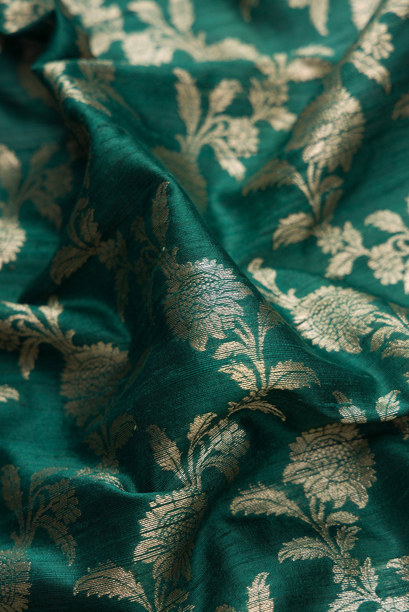 Close up of Bottle Green Dual Tone Banarasi Silk Saree with Zari Brocade on the body and Zari Border.  displaying folds