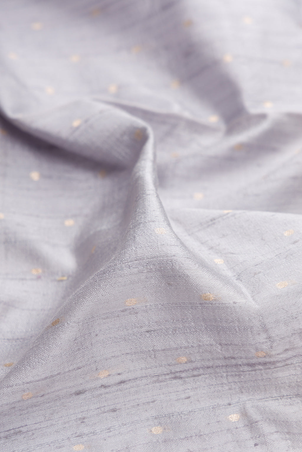 Close up of Grey Dual Tone Banarasi Silk Saree with Zari Butta on the body and Zari Border.  displaying folds