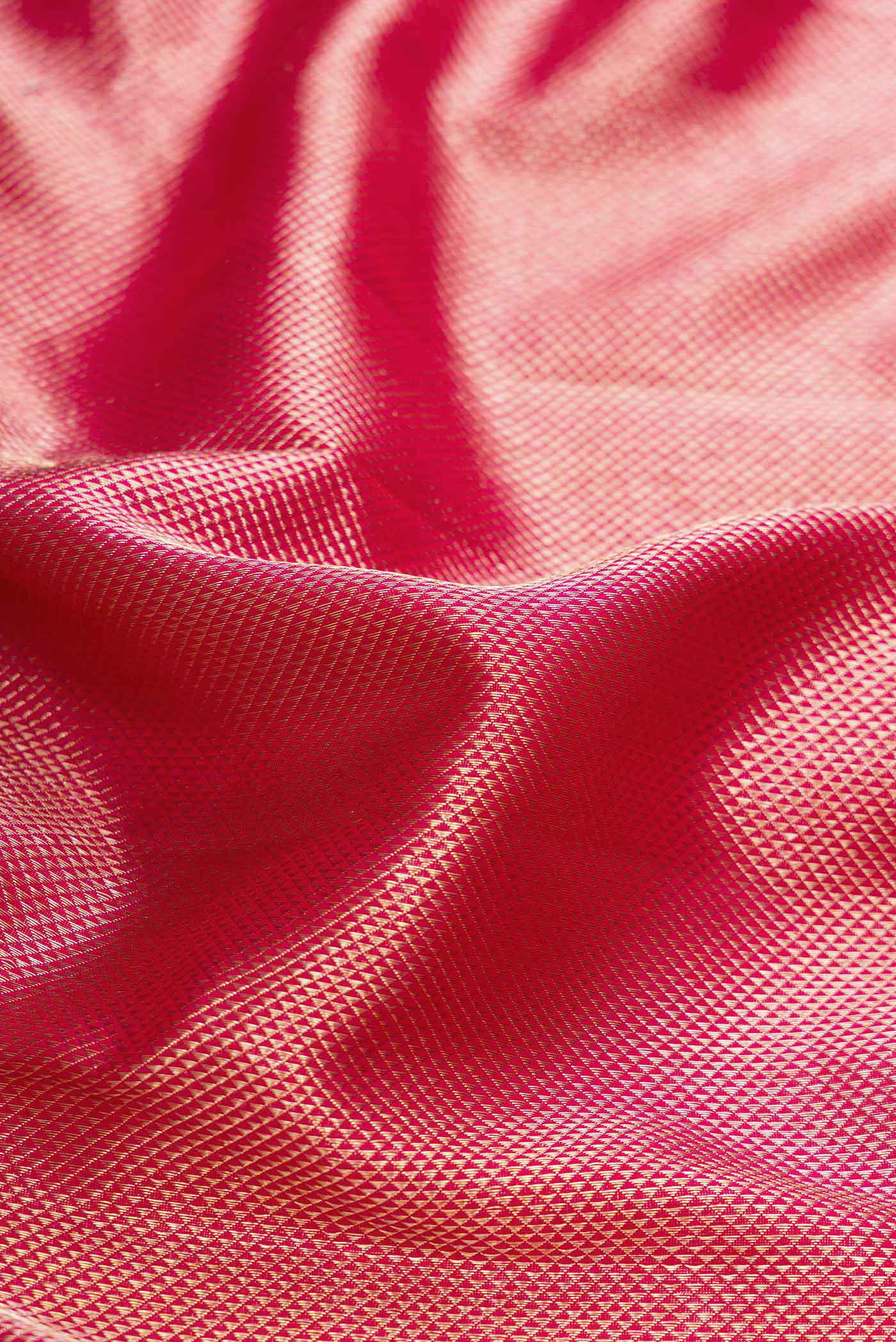 Close up of Pink Dual Tone Kanchipuram Silk Saree with Zari Brocade on the body and Zari Border displaying folds