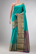 Sea Green Dual Tone Kanchipuram Silk Saree with Plain Body and Fancy Border displayed on a mannequin
