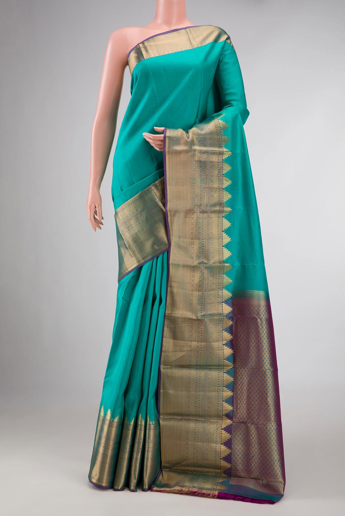 Sea Green Dual Tone Kanchipuram Silk Saree with Plain Body and Fancy Border displayed on a mannequin