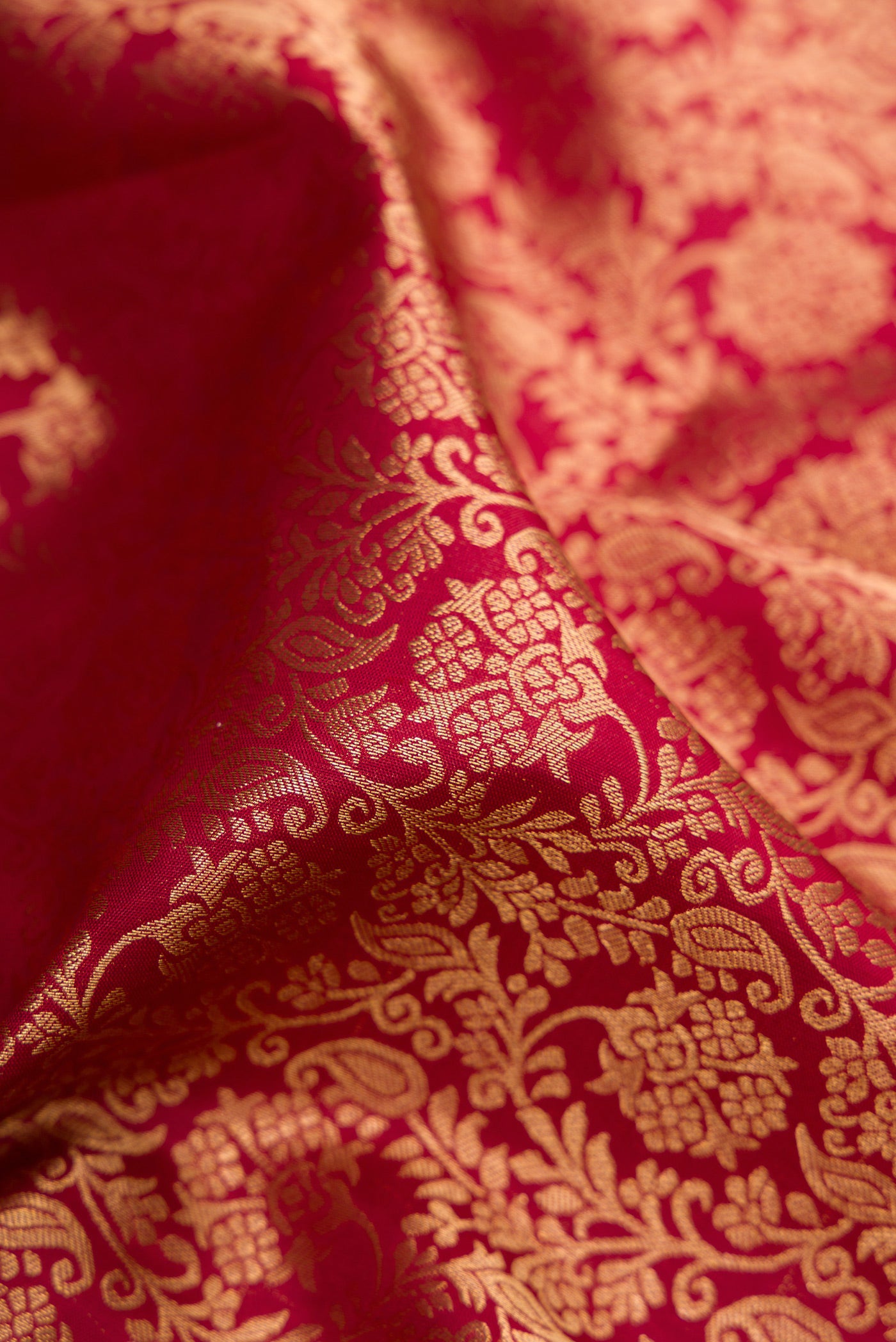 Close up of Maroon Kanchipuram Silk Saree with Zari Brocade on the body and Zari Border.  displaying folds