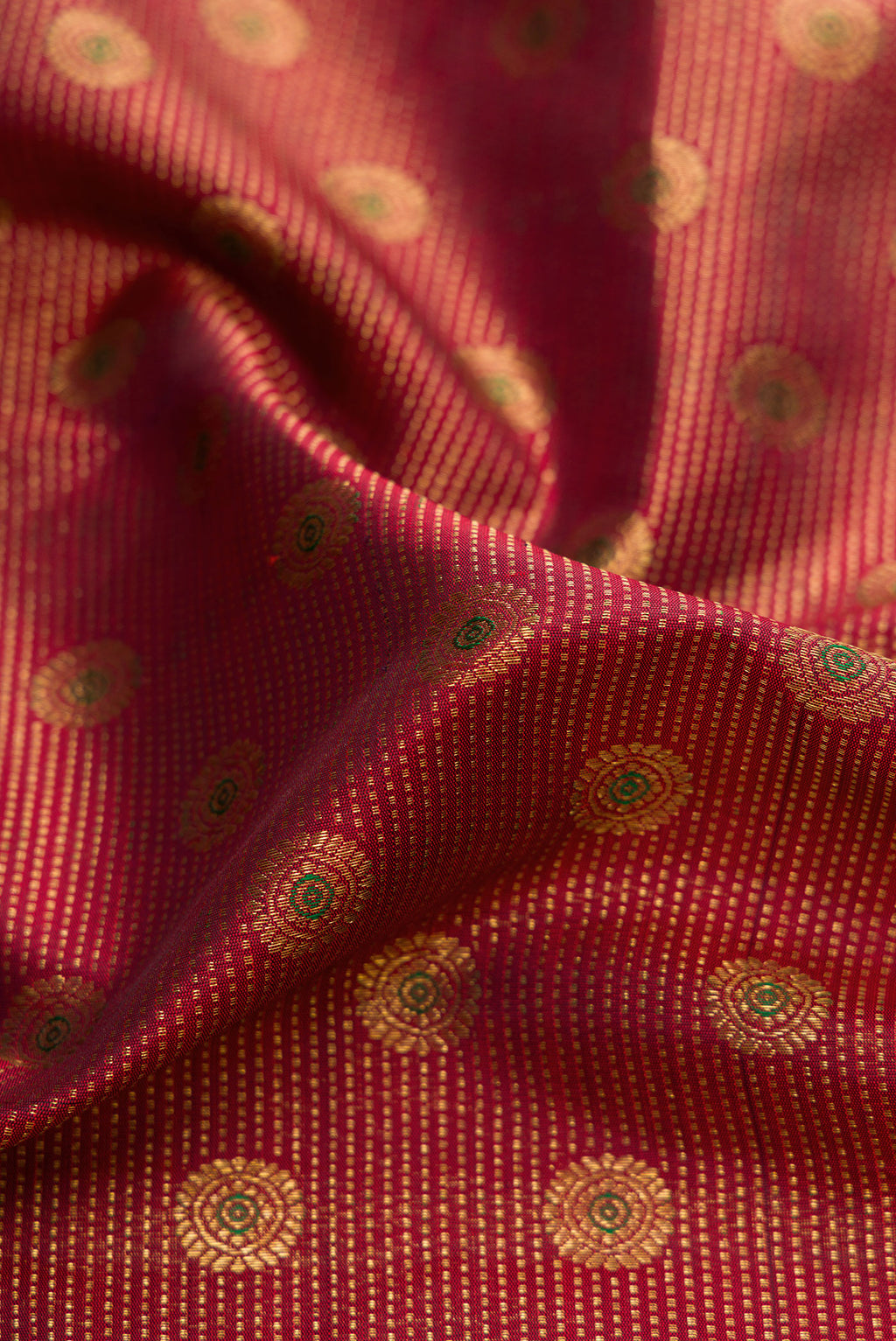 Close up of Maroon Dual Tone Kanchipuram Silk Saree with Zari Brocade on the body and Zari Border.  displaying folds