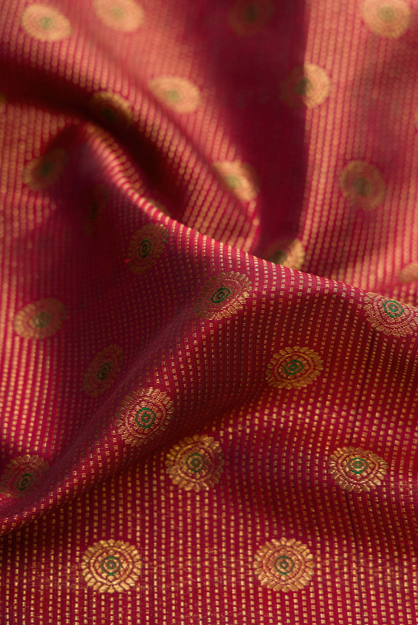 Close up of Maroon Dual Tone Kanchipuram Silk Saree with Zari Brocade on the body and Zari Border.  displaying folds