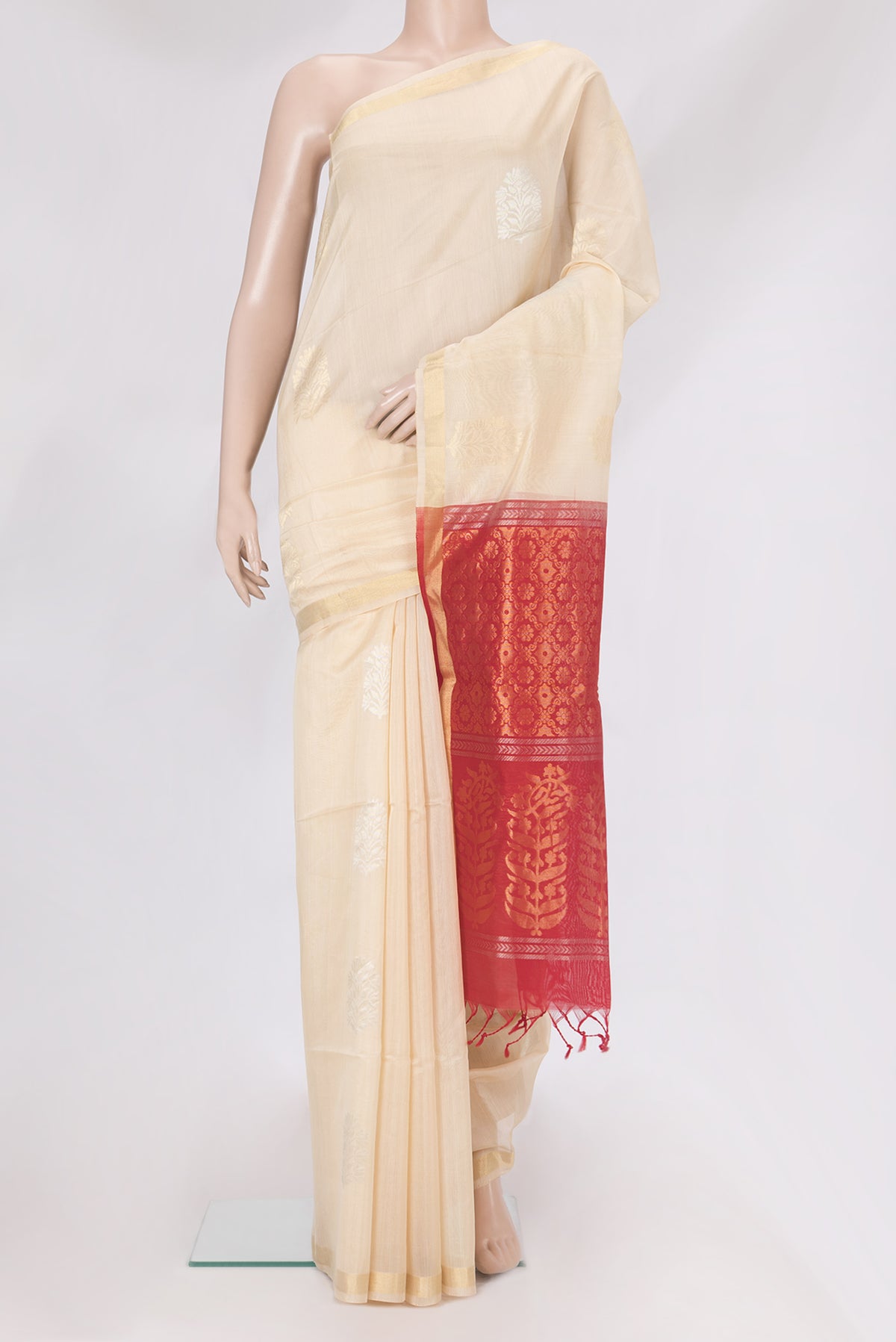 Off White Silk Cotton Saree with Zari Butta on the body and Zari Border.  displayed on a mannequin