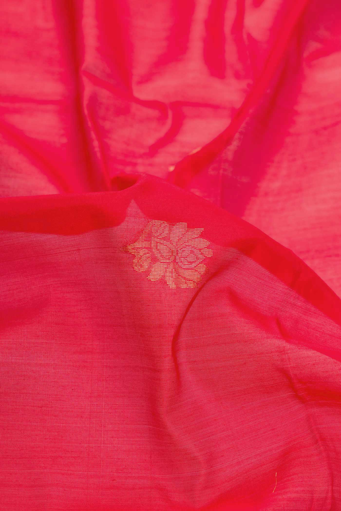 Close up of Red Dual Tone Silk Cotton Saree with Zari Butta on the body and Zari Border displaying folds