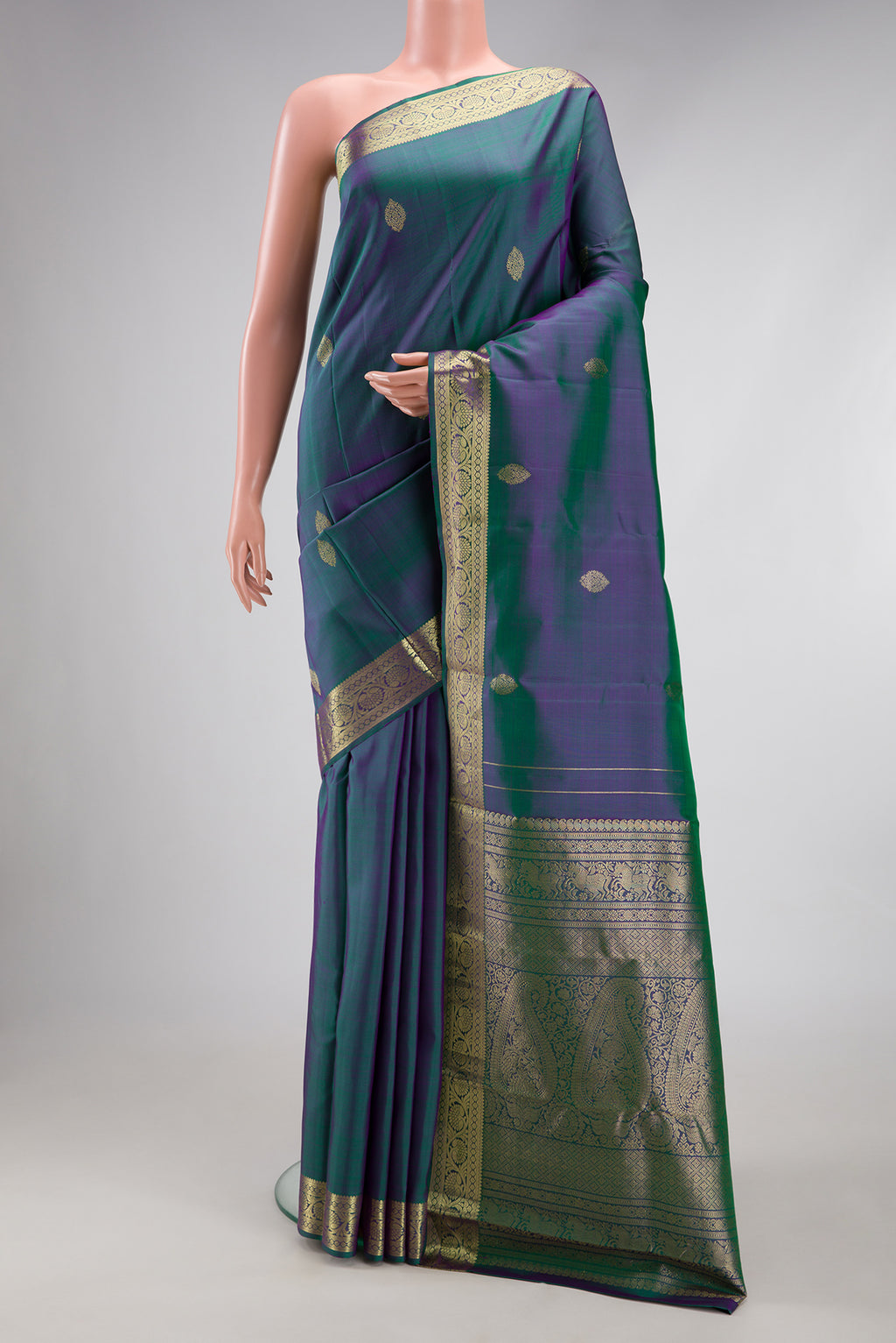Peacock Blue Dual Tone Kanchipuram Silk Saree with Zari Butta on the body and Zari Border.  displayed on a mannequin