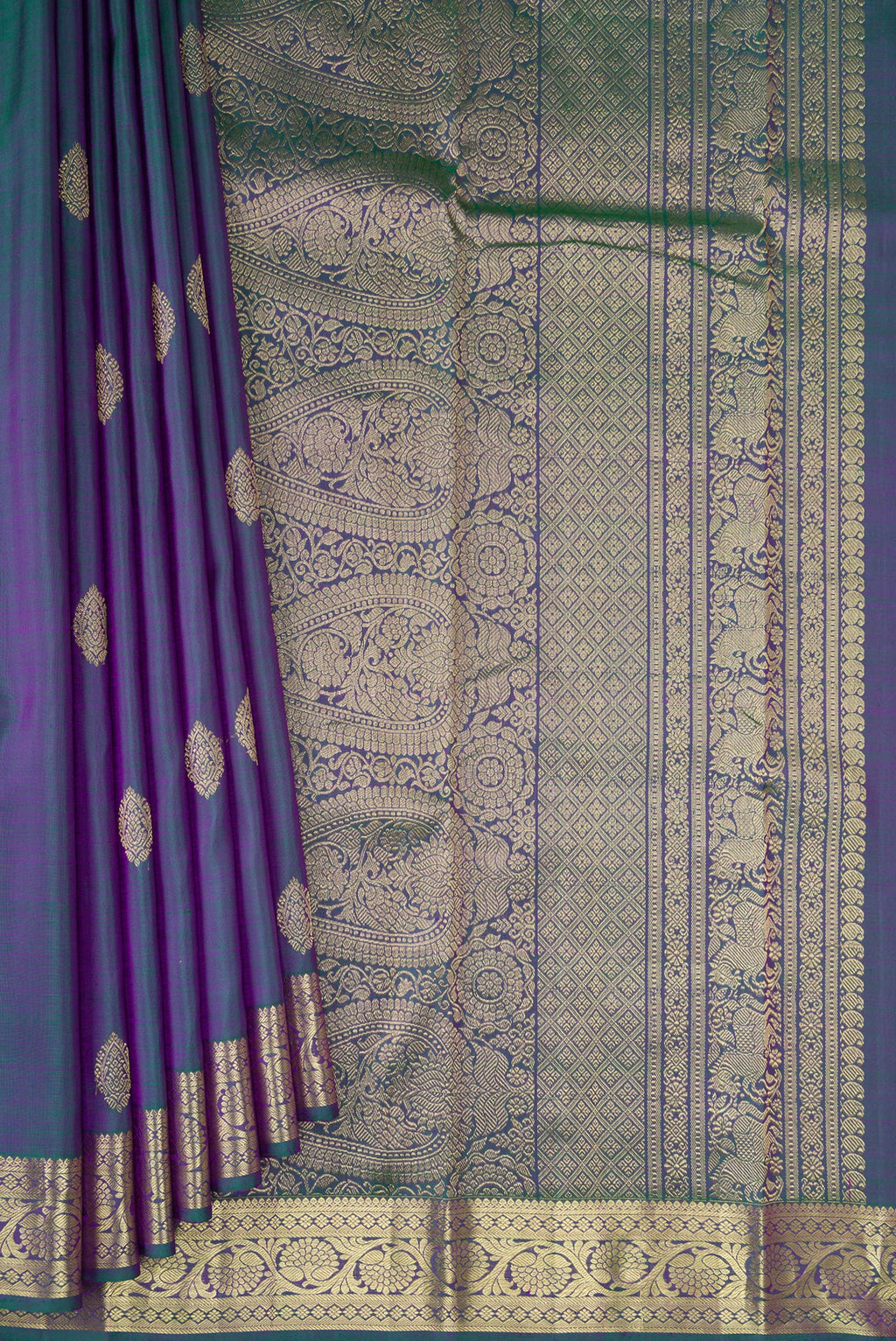 Pleats and pallu of Peacock Blue Dual Tone Kanchipuram Silk Saree with Zari Butta on the body and Zari Border. 