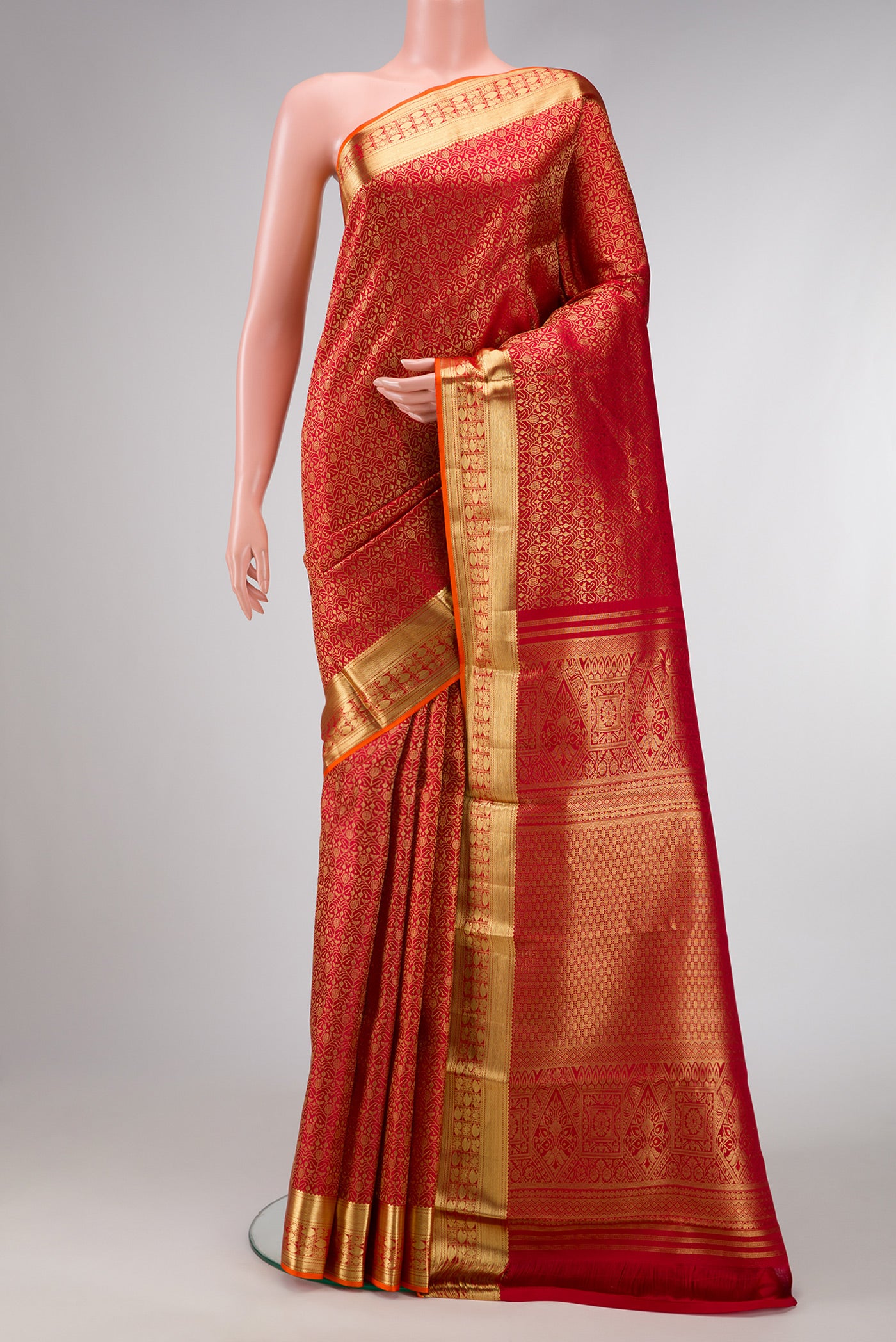 Red Dual Tone Kanchipuram Silk Saree with Zari Brocade on the body and Zari Border.  displayed on a mannequin