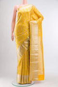 Yellow Kanchipuram Silk Saree with Zari Brocade on the body and Zari Border displayed on a mannequin