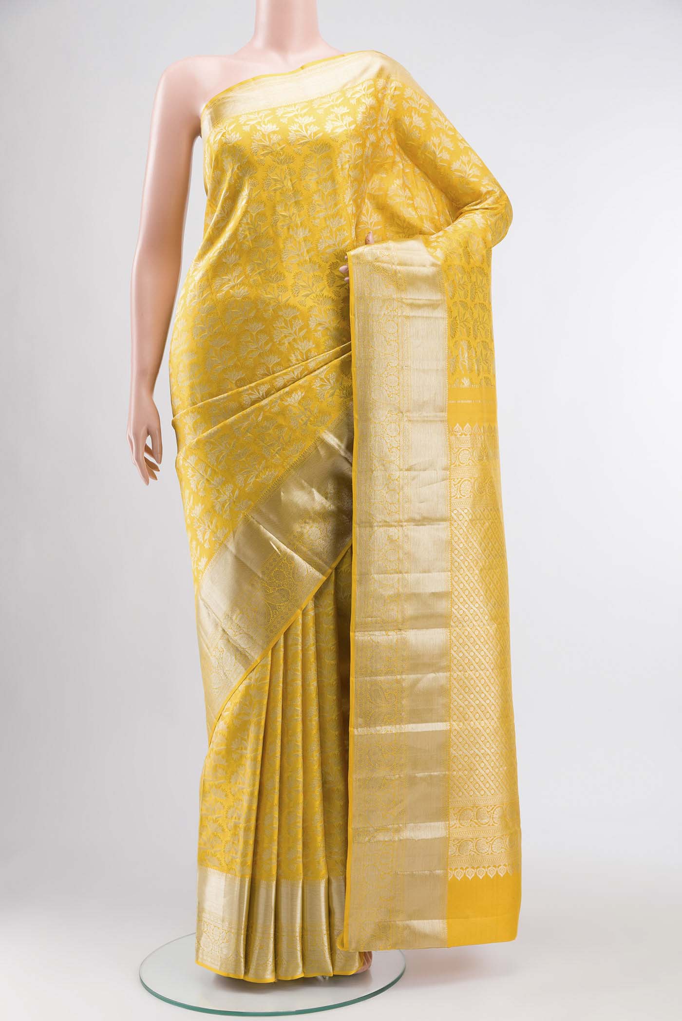 Yellow Kanchipuram Silk Saree with Zari Brocade on the body and Zari Border displayed on a mannequin