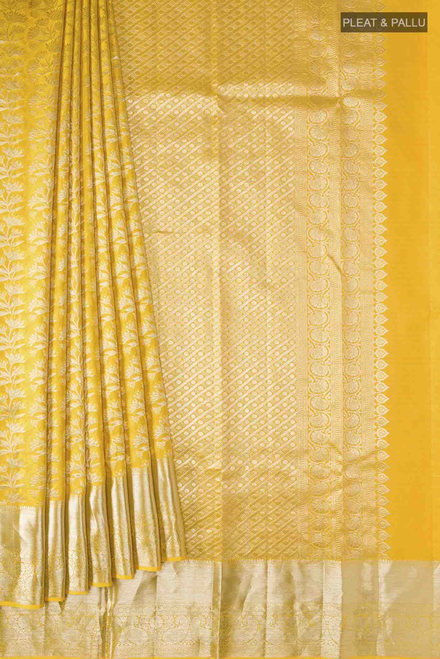 Pleats and pallu of Yellow Kanchipuram Silk Saree with Zari Brocade on the body and Zari Border