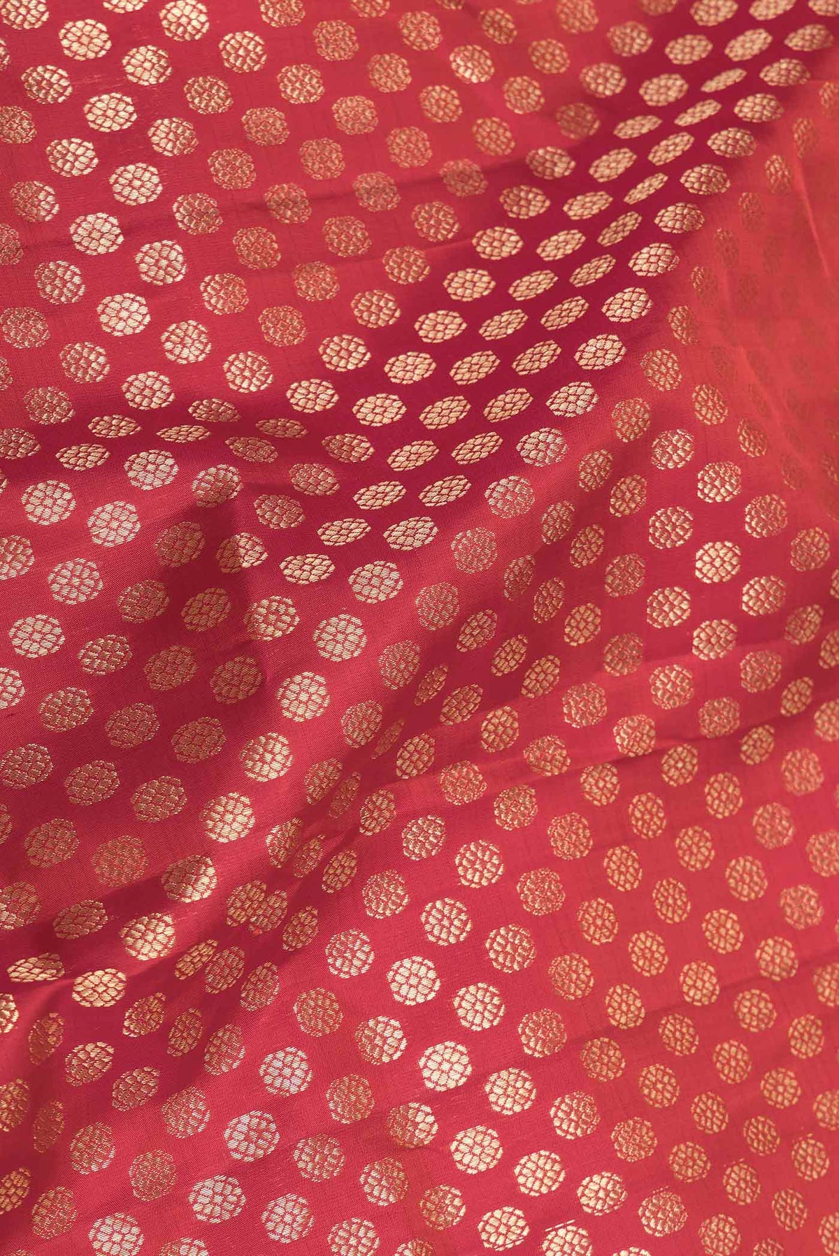 Close up of Red Dual Tone Kanchipuram Saree with Zari Brocade on the body and Zari Border displaying folds