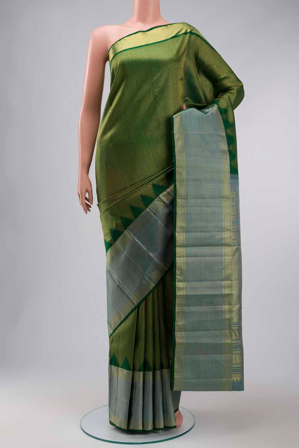 Green Kanchipuram Silk Saree with Zari Brocade on the body and Zari Border displayed on a mannequin