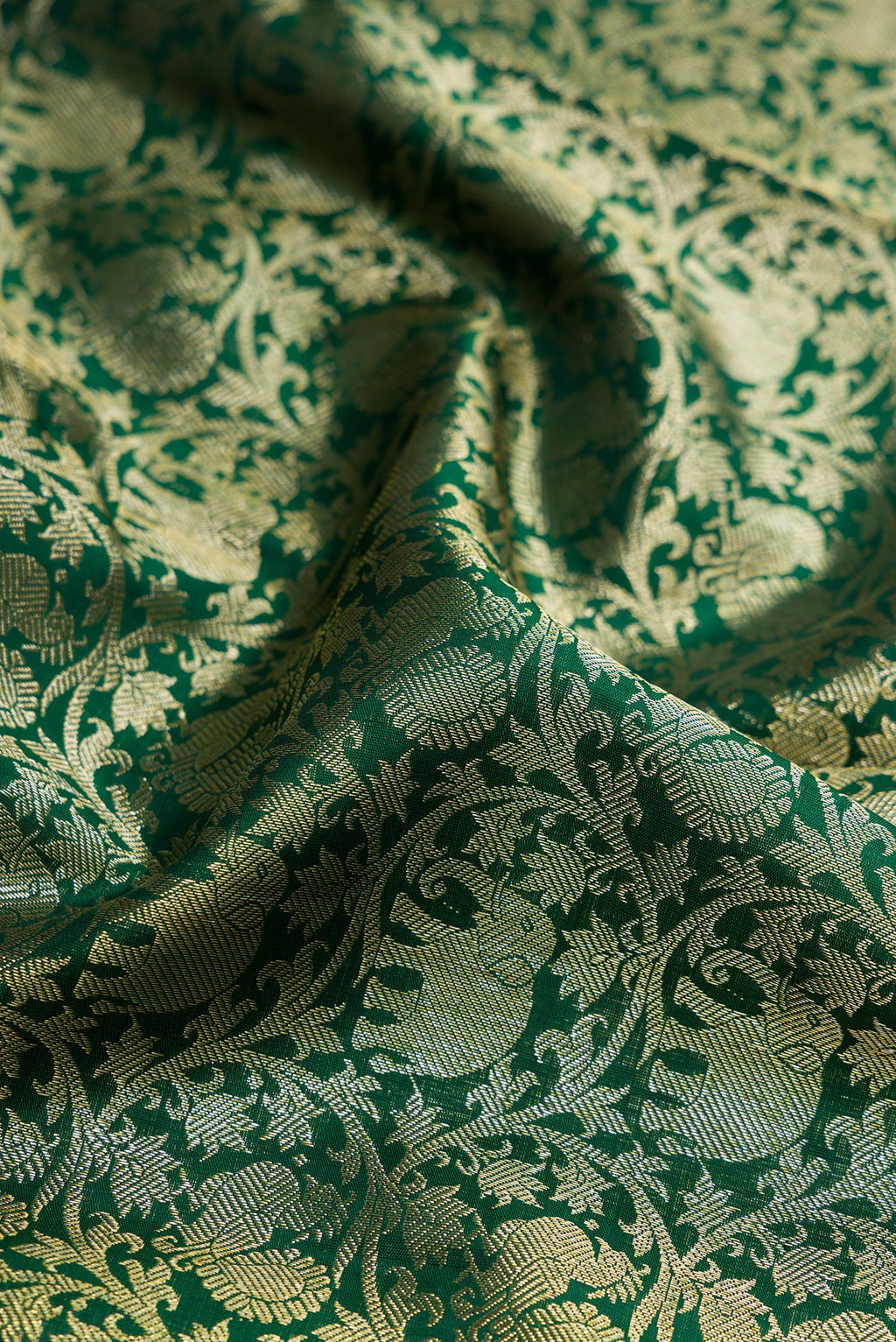 Close up of Green Dual Tone Kanchipuram Silk Saree with Zari Brocade on the body and Zari Border.  displaying folds