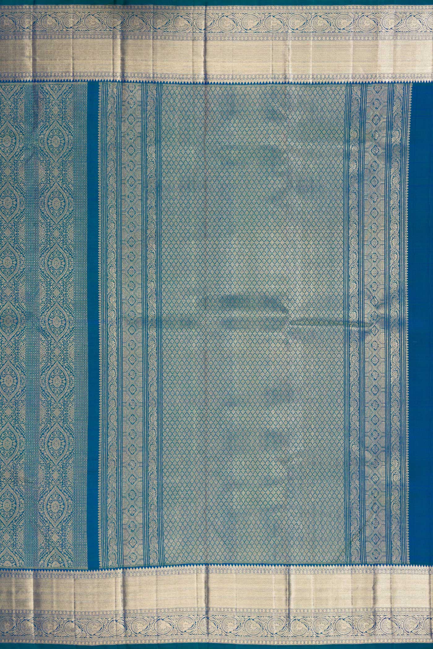 Close up image of the pallu of Peacock Blue Dual Tone Kanchipuram Silk Saree with Zari Brocade on the body and Zari Border. 