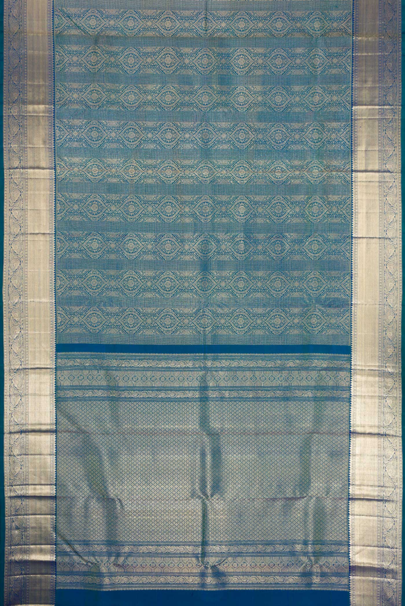 Flat view of Peacock Blue Dual Tone Kanchipuram Silk Saree with Zari Brocade on the body and Zari Border. 