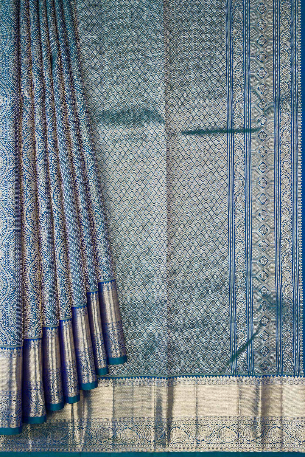Pleats and pallu of Peacock Blue Dual Tone Kanchipuram Silk Saree with Zari Brocade on the body and Zari Border. 
