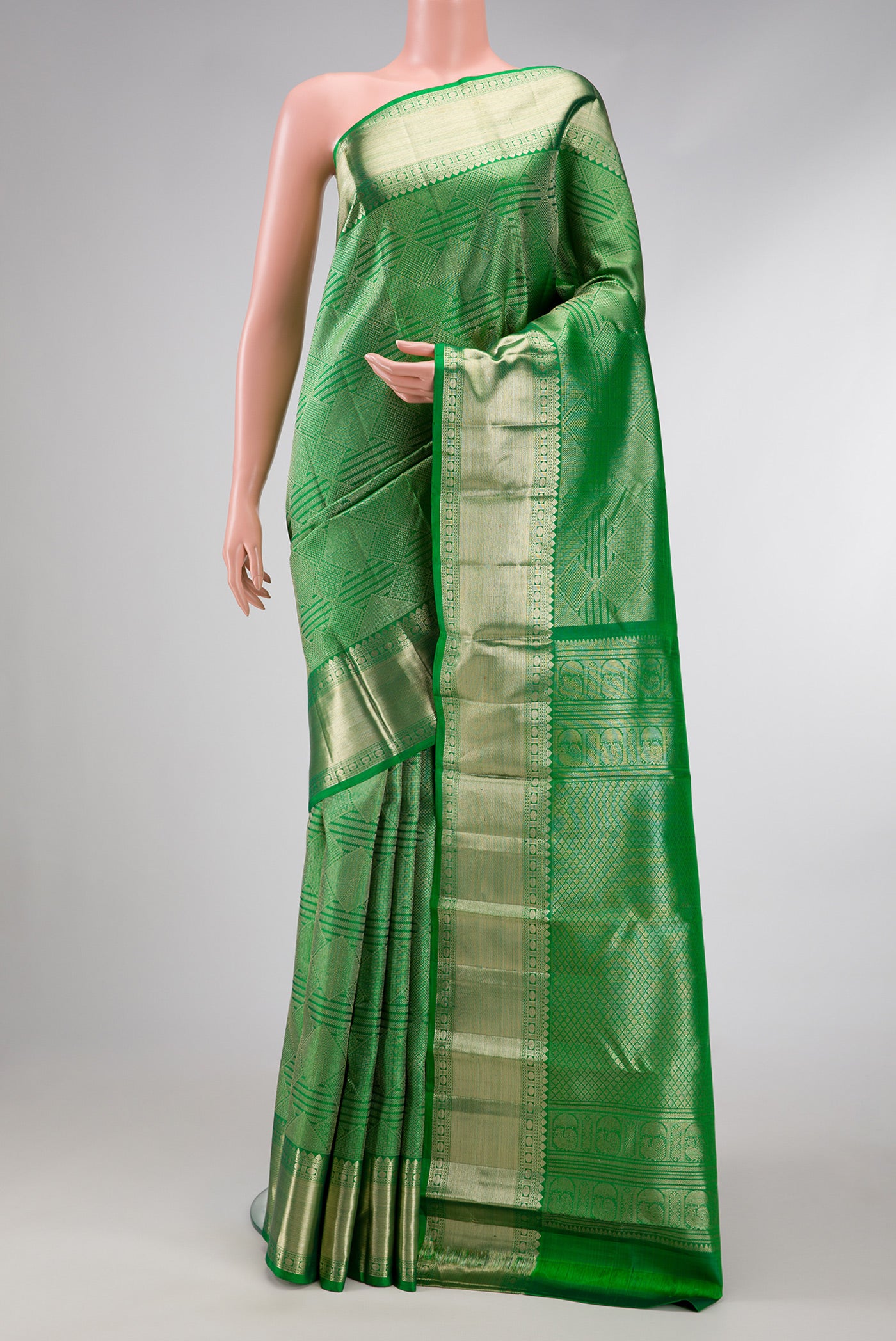 Green Dual Tone Kanchipuram Silk Saree with Zari Brocade on the body and Zari Border.  displayed on a mannequin