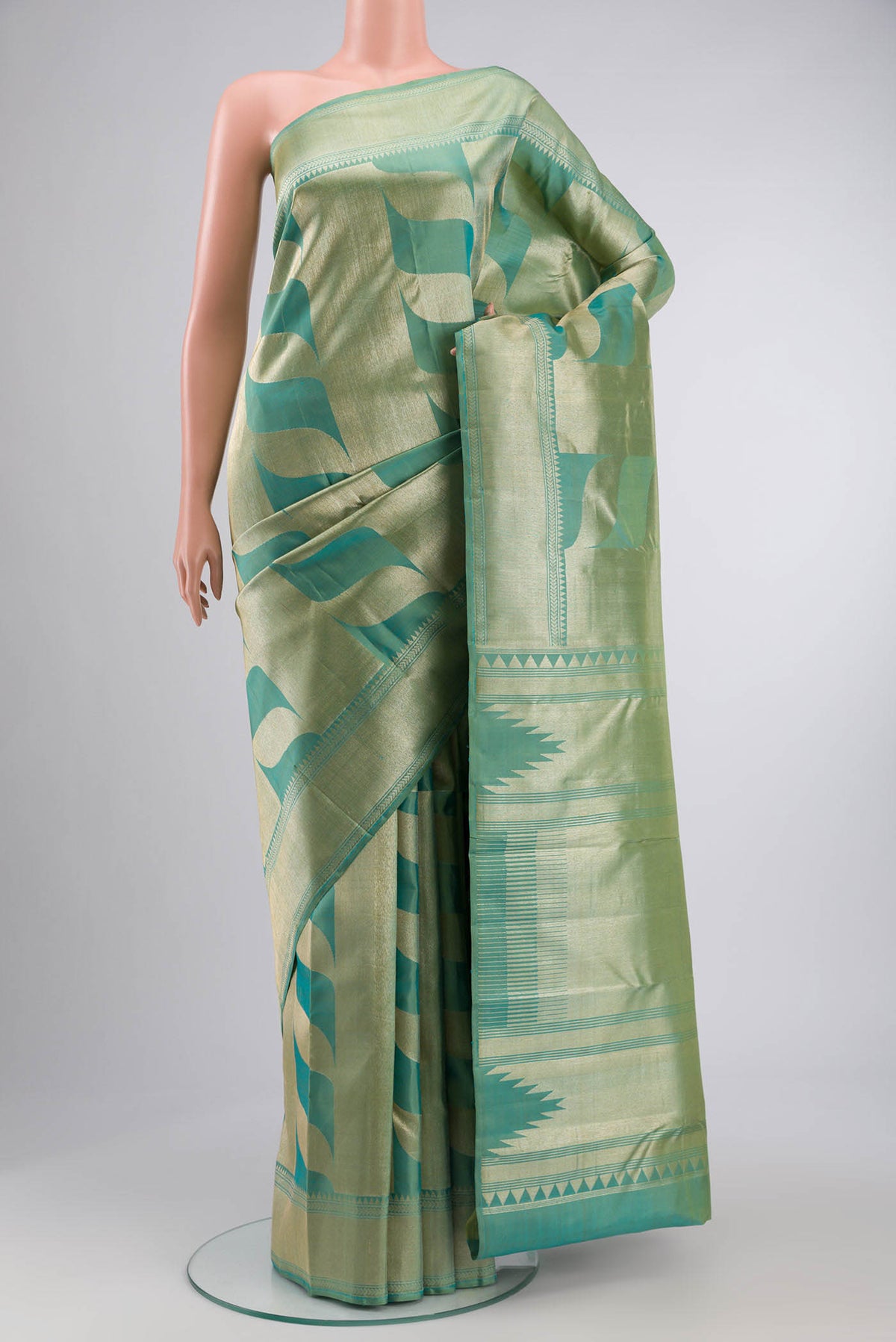 Green Kanchipuram Silk Saree with Zari Butta on the body and Zari Border displayed on a mannequin