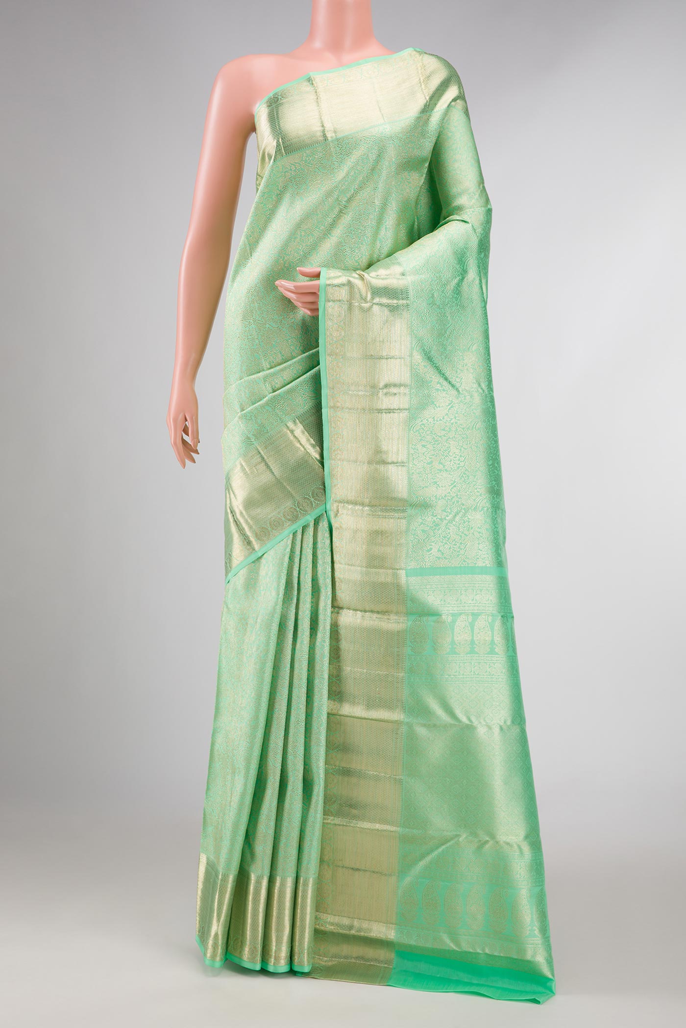 Light Green Dual Tone Kanchipuram Silk Saree with Zari Brocade on the body and Zari Border displayed on a mannequin
