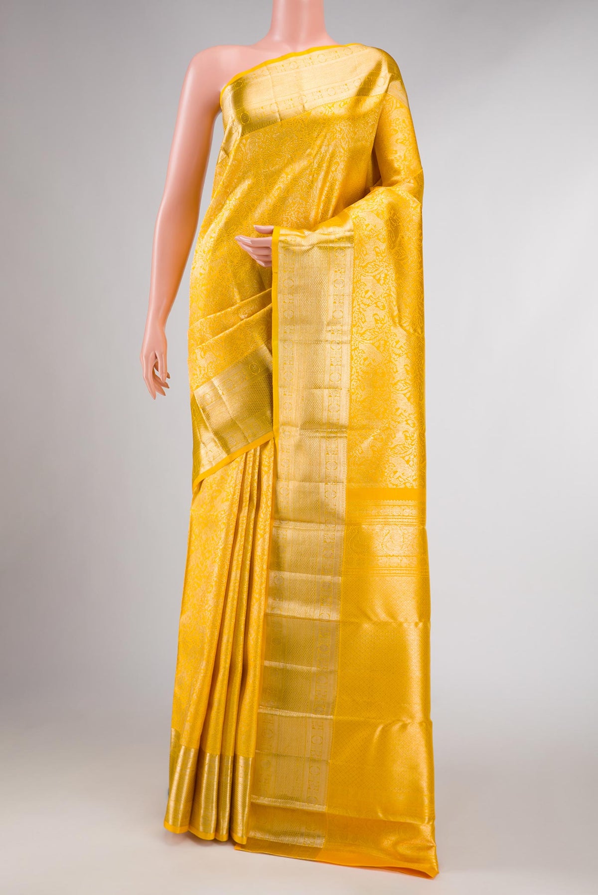 Yellow Dual Tone Kanchipuram Silk Saree with Zari Brocade on the body and Zari Border displayed on a mannequin