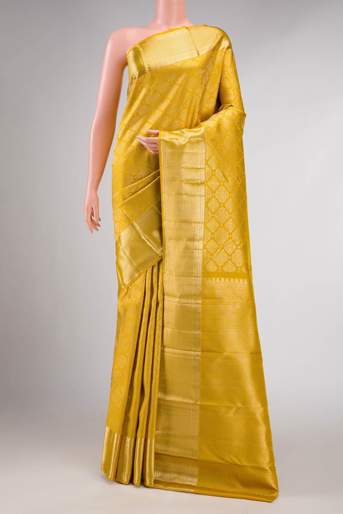 Mustard Dual Tone Kanchipuram Silk Saree with Zari Brocade on the body and Zari Border displayed on a mannequin