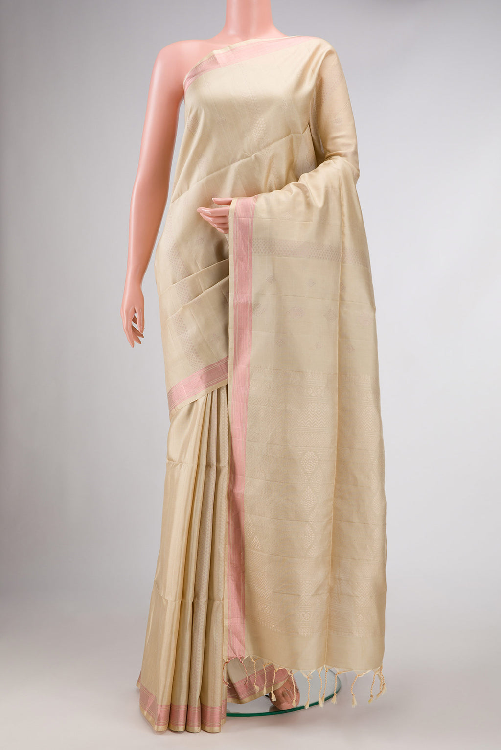 Beige Dual Tone Soft Silk Saree with Zari Butta on the body and Zari Border.  displayed on a mannequin
