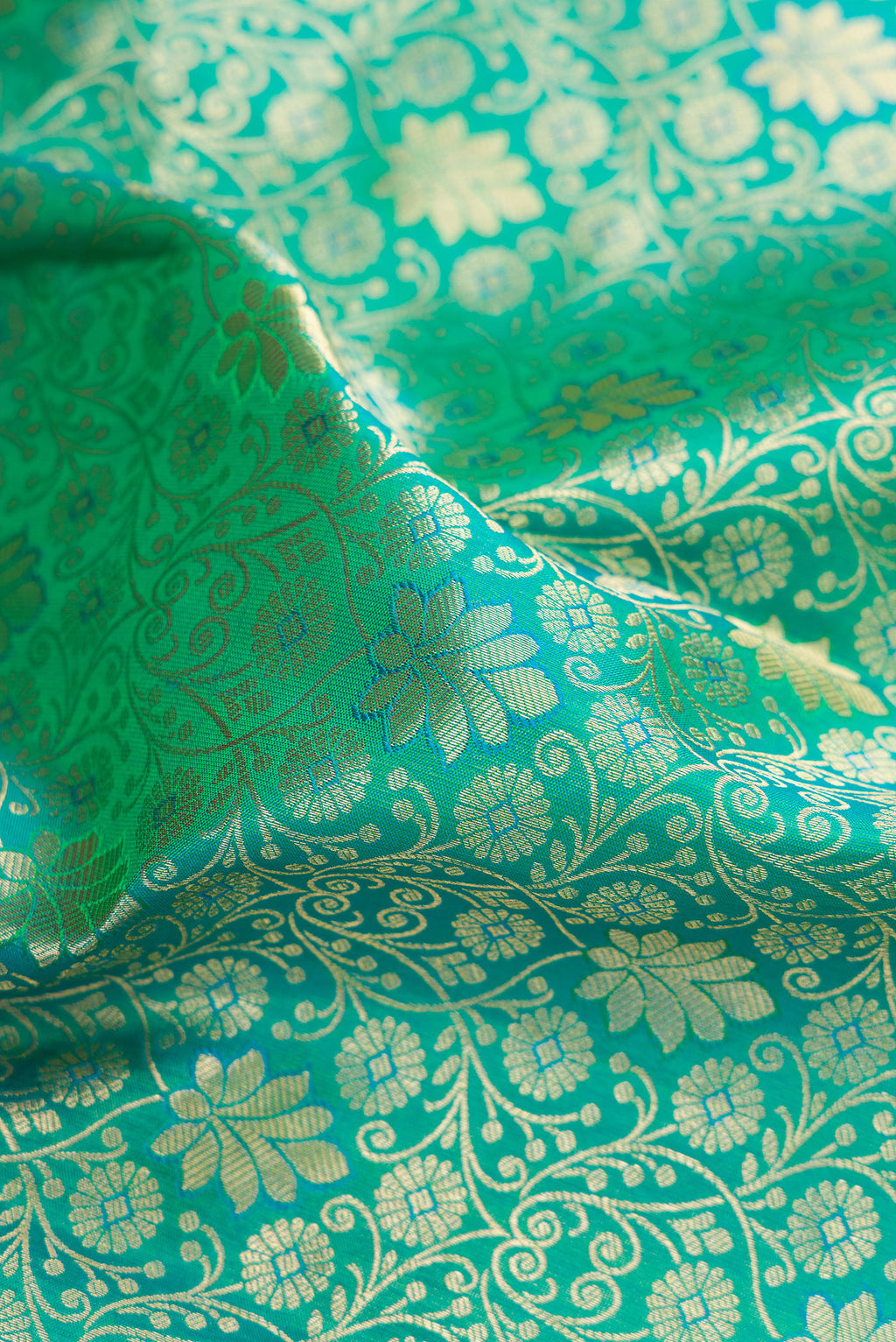 Close up of Sea Green Kanchipuram Silk Saree with Zari Brocade on the body and Zari Border.  displaying folds