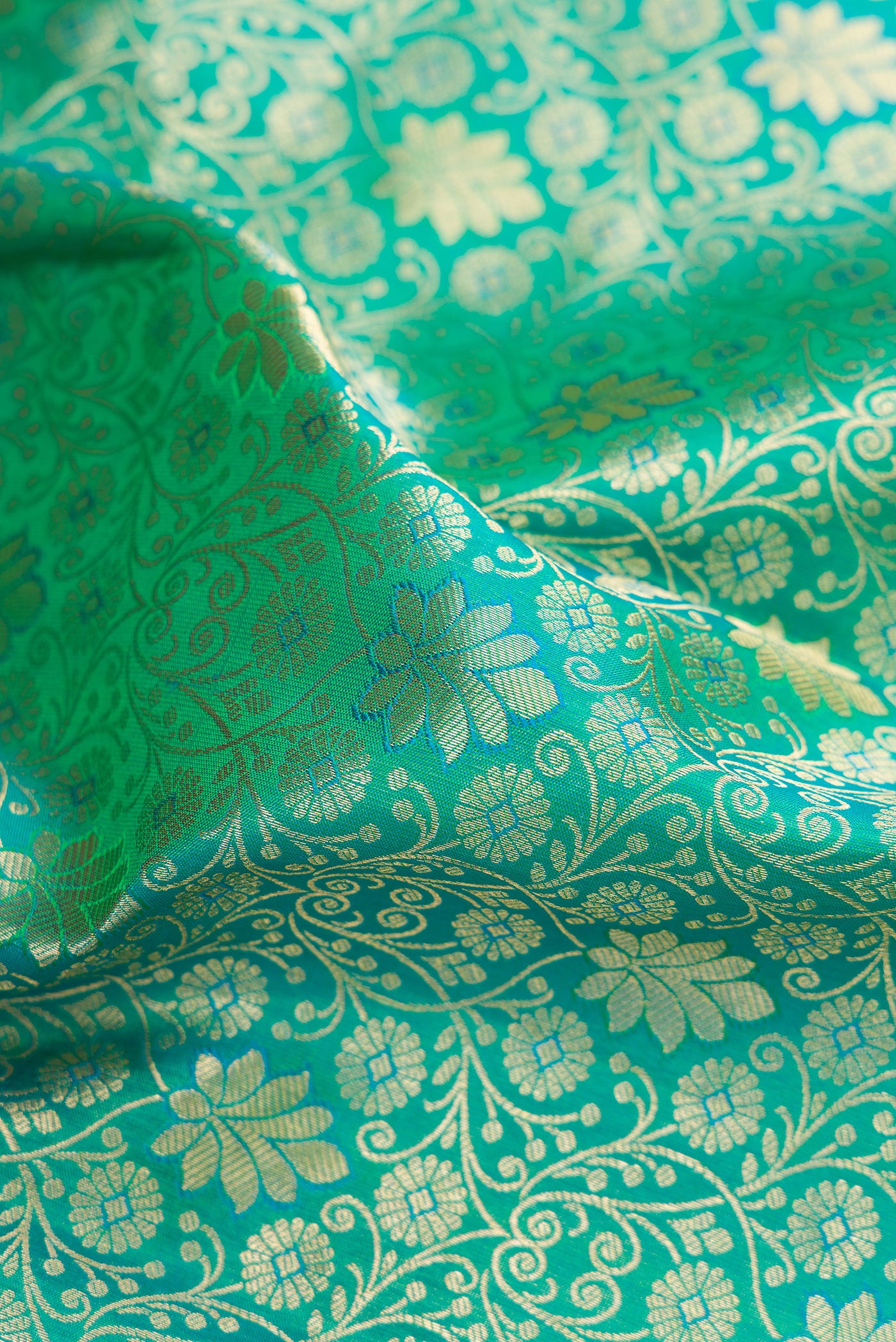 Close up of Sea Green Kanchipuram Silk Saree with Zari Brocade on the body and Zari Border.  displaying folds