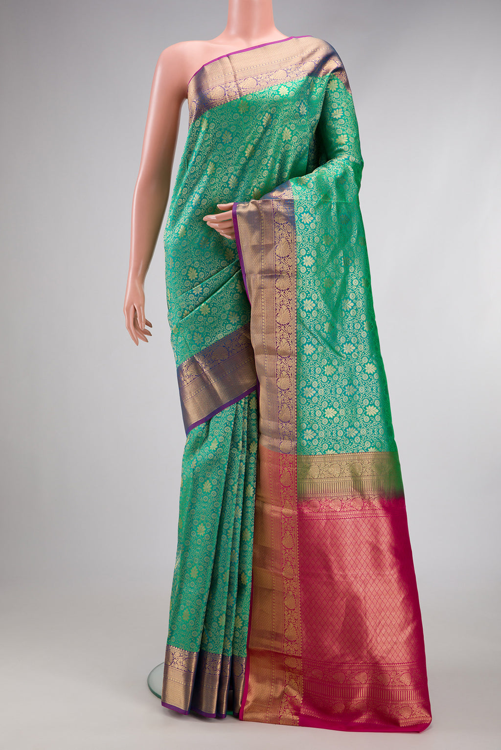 Sea Green Kanchipuram Silk Saree with Zari Brocade on the body and Zari Border.  displayed on a mannequin