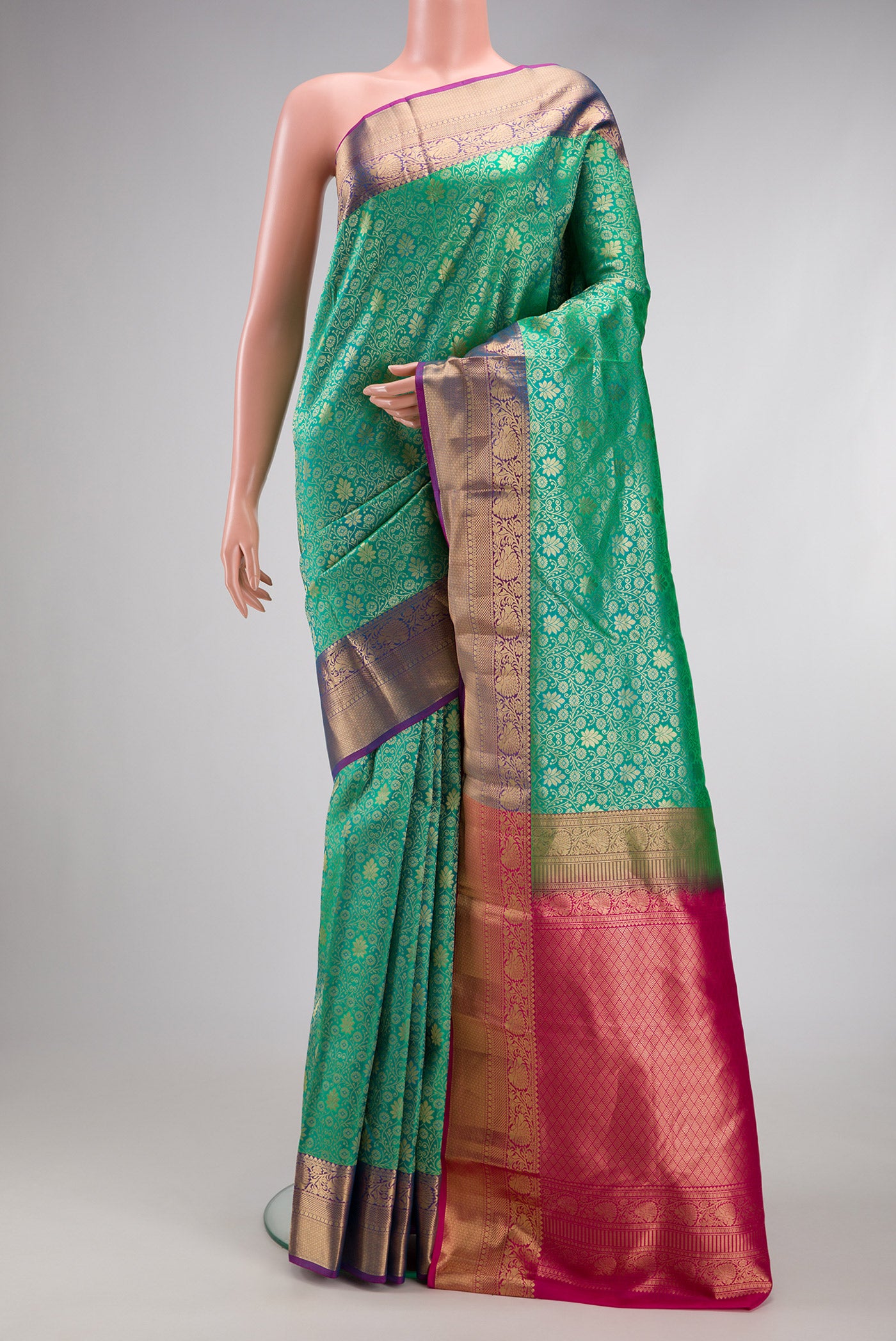 Sea Green Kanchipuram Silk Saree with Zari Brocade on the body and Zari Border.  displayed on a mannequin