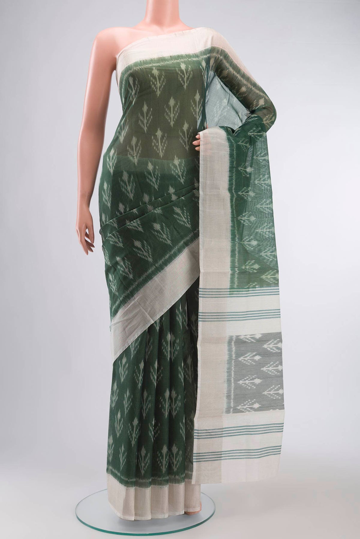 Green Silk Cotton Saree with Ikat Print on the body and Zari Border displayed on a mannequin