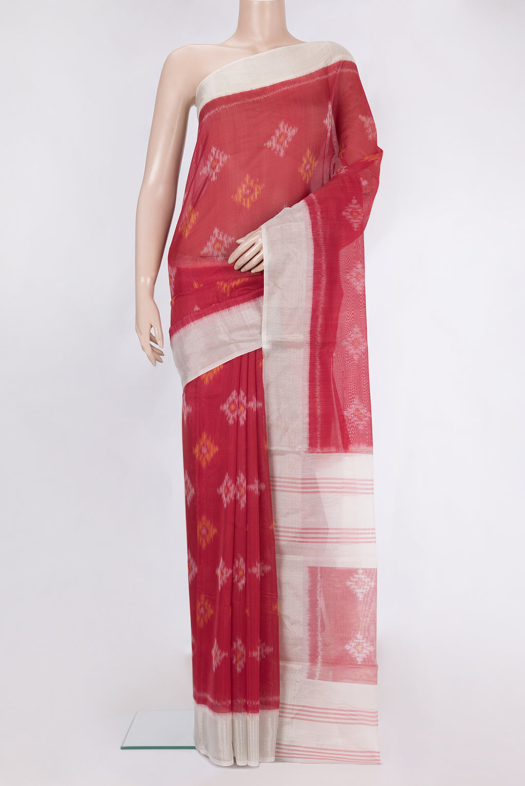 Red Silk Cotton Saree with Ikat Print on the body and Zari Border.  displayed on a mannequin