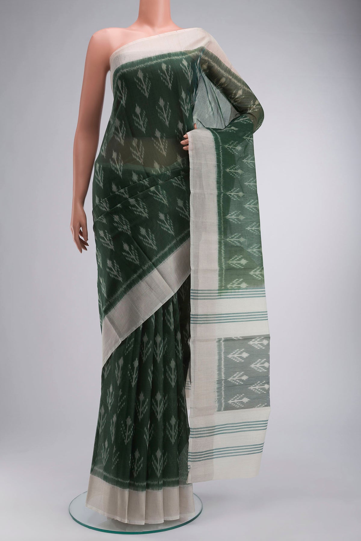 Green Silk Cotton Saree with Ikat Print on the body and Zari Border displayed on a mannequin