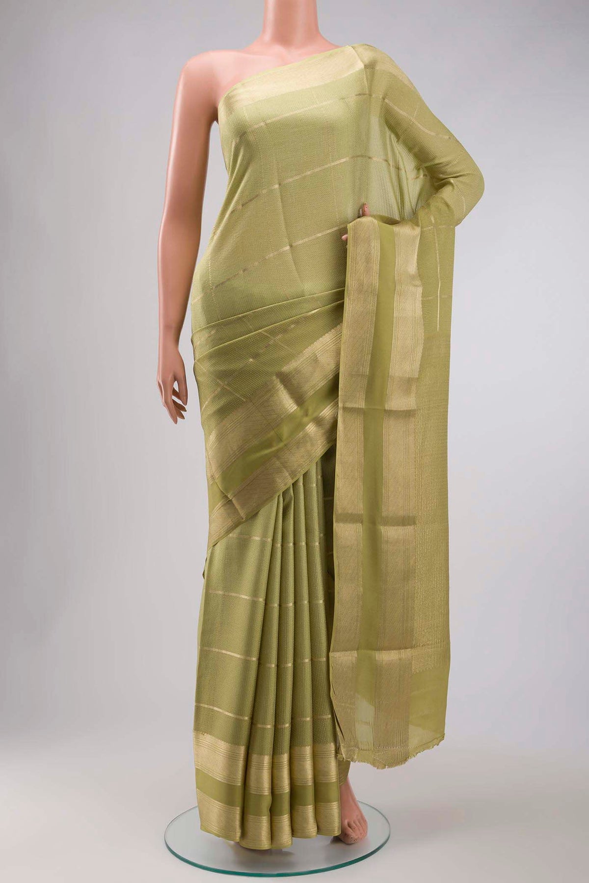 Green Mysore Crepe Saree with Checked design on the body and Zari Border displayed on a mannequin