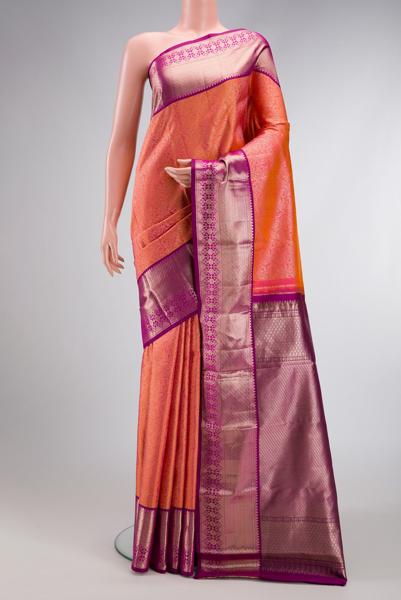 Coral Dual Tone Kanchipuram Silk Saree with Zari Brocade on the body and Zari Border.  displayed on a mannequin