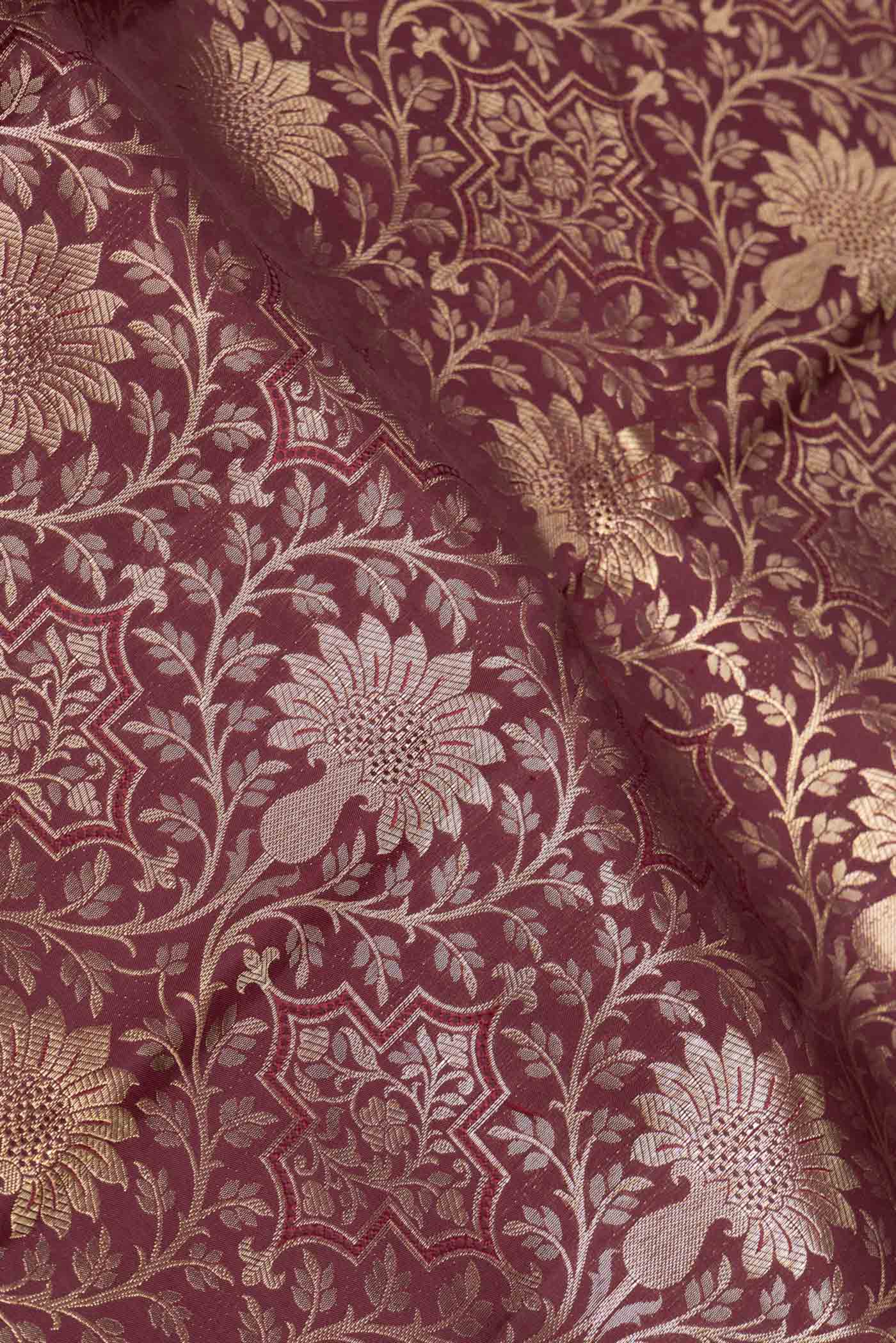 Close up of Maroon Dual Tone Kanchipuram Saree with Zari Brocade on the body and Zari Border displaying folds