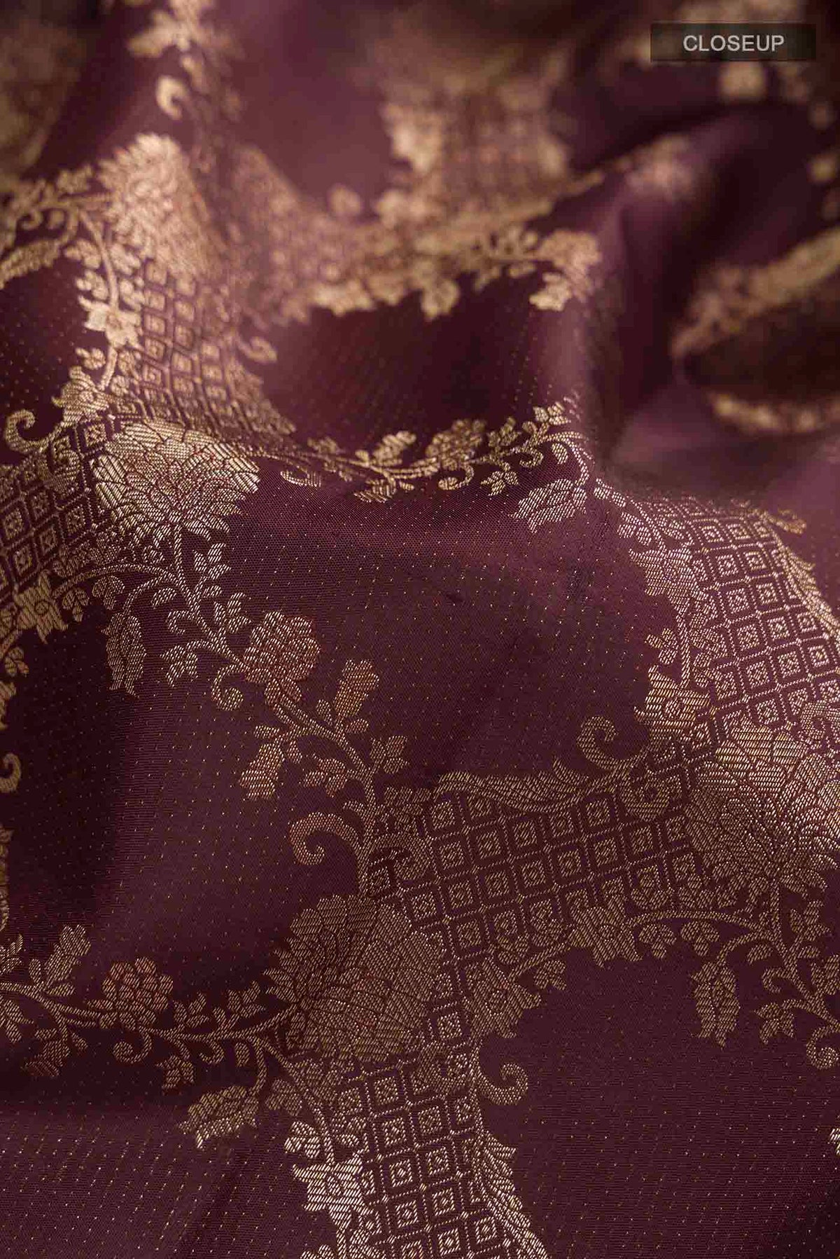 Close up of Brown Kanchipuram Silk Saree with Zari Butta on the body and Zari Border displaying folds
