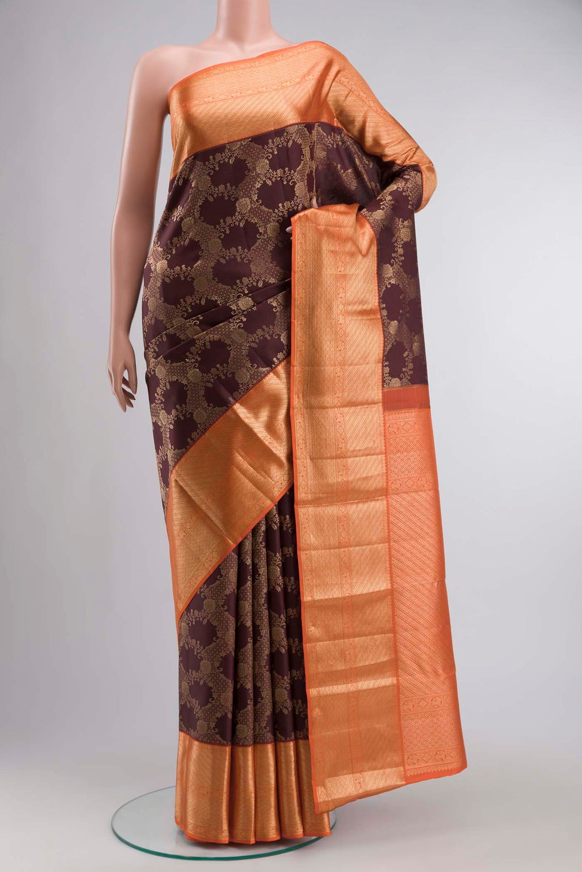 Brown Kanchipuram Silk Saree with Zari Butta on the body and Zari Border displayed on a mannequin