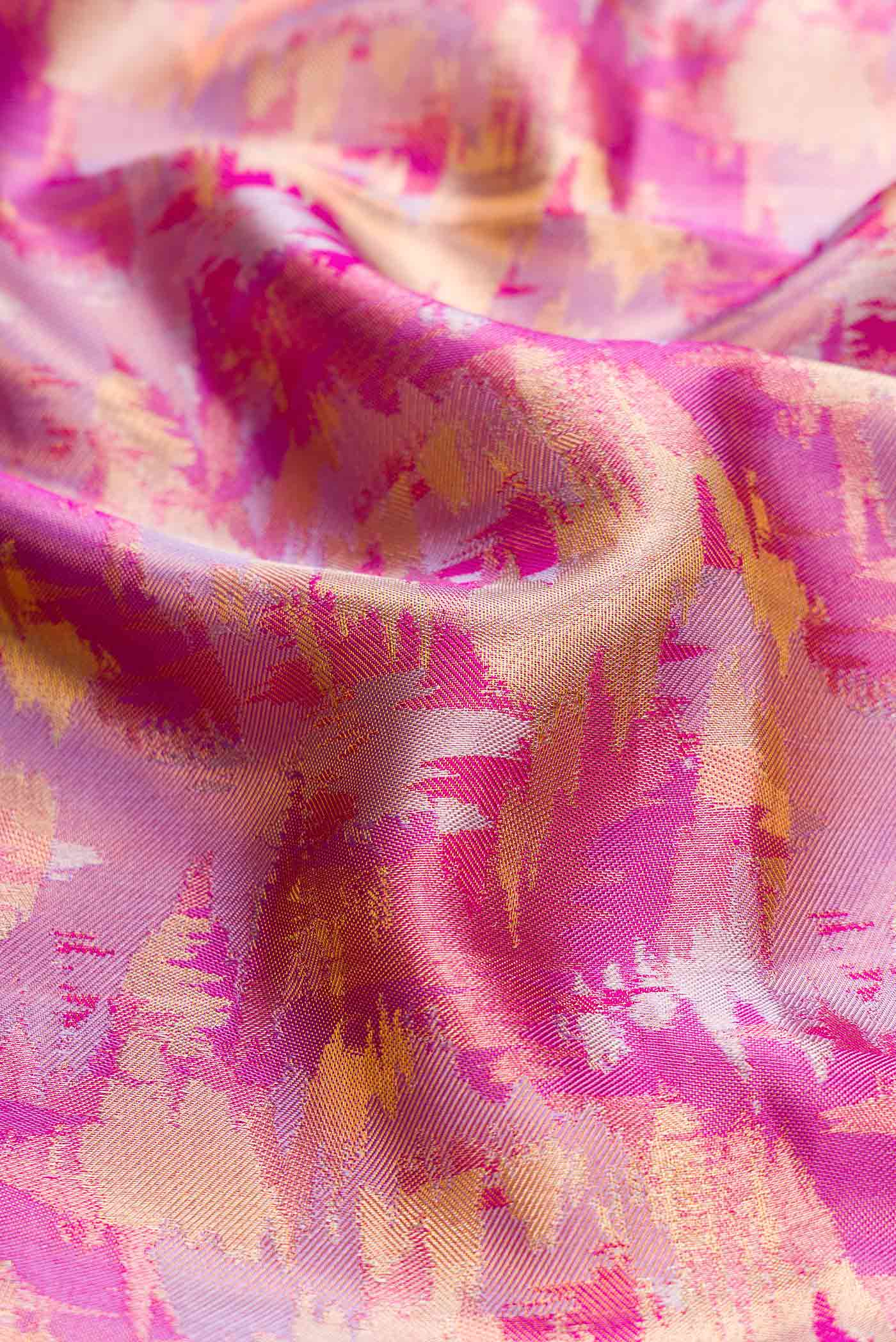 Close up of Pink Dual Tone Kanchipuram Tissue Silk Saree with Zari Brocade on the body and Zari Border displaying folds