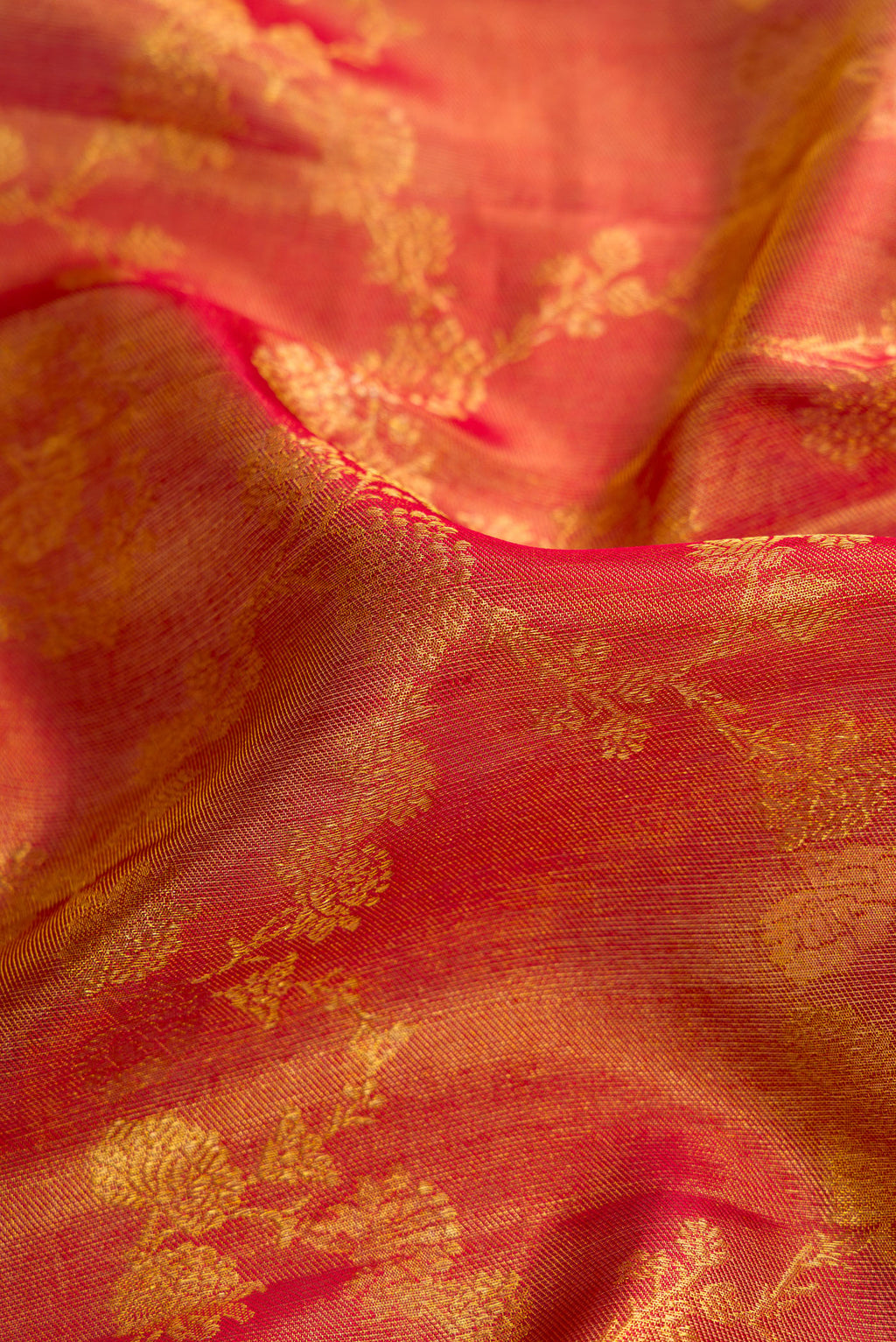 Close up of Dark Pink Dual Tone Kanchipuram Tissue Silk Saree with Zari Brocade on the body and Temple Border.  displaying folds