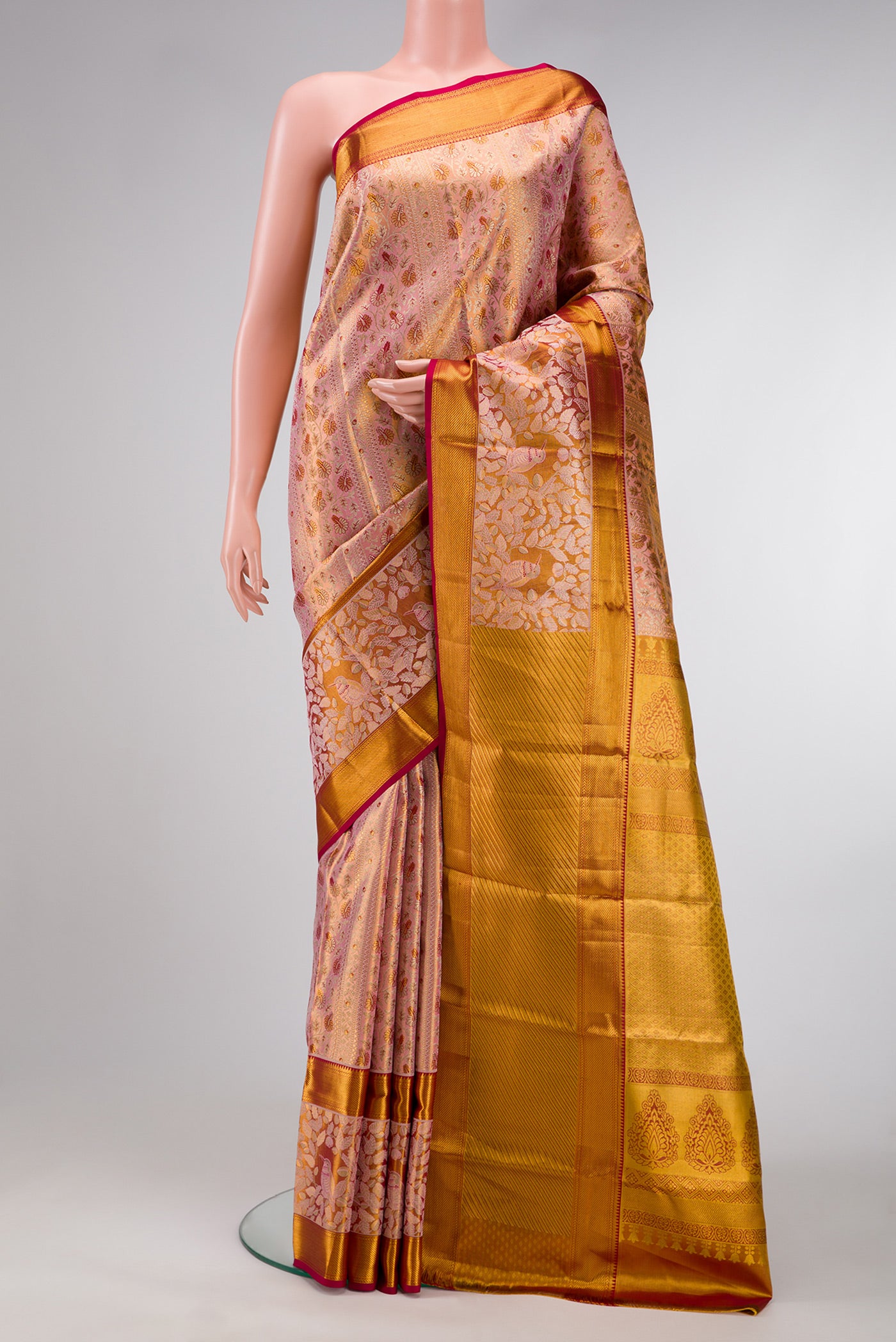 Golden Peach Dual Tone Kanchipuram Tissue Silk Saree with Zari Brocade on the body and Zari Border.  displayed on a mannequin