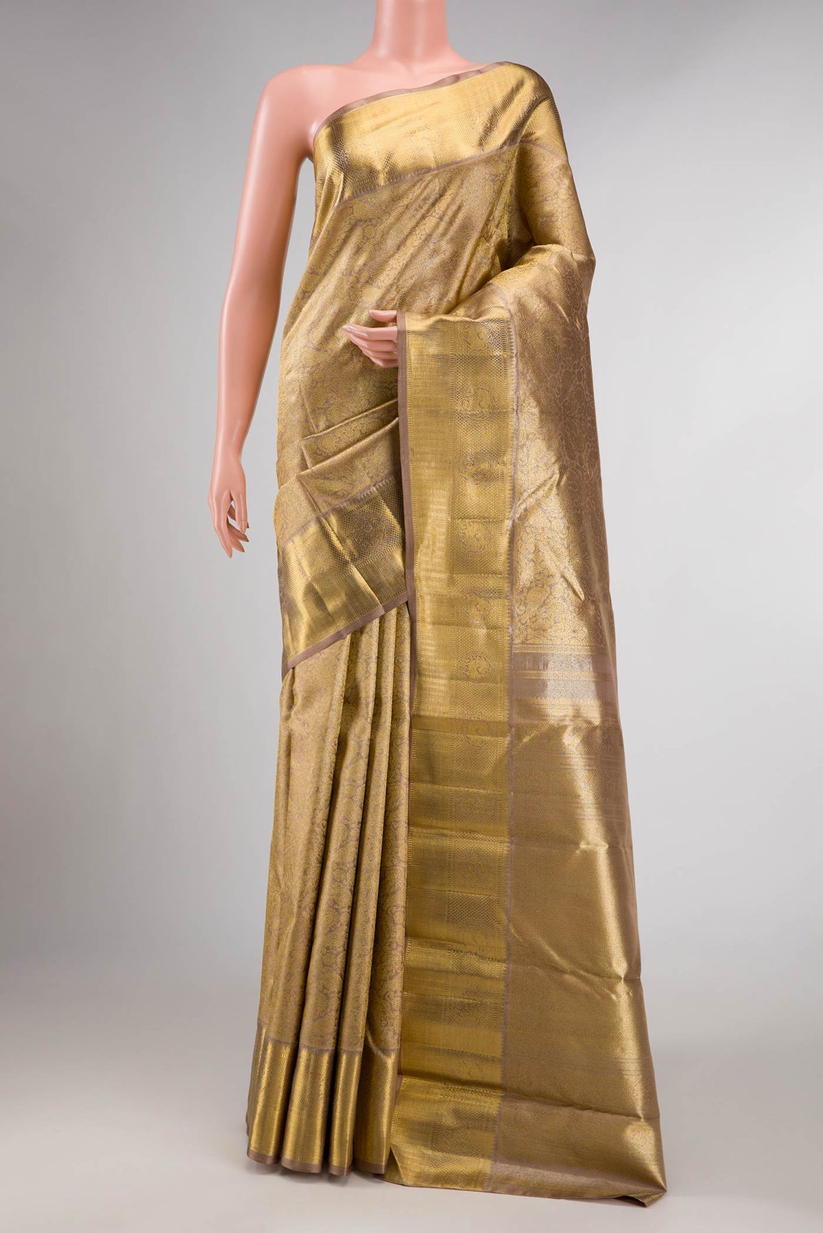 Pure Silk Pure Zari Dark Beige Dual Tone Kanchipuram Saree with Zari Brocade on the body and Zari Border displayed on a mannequin