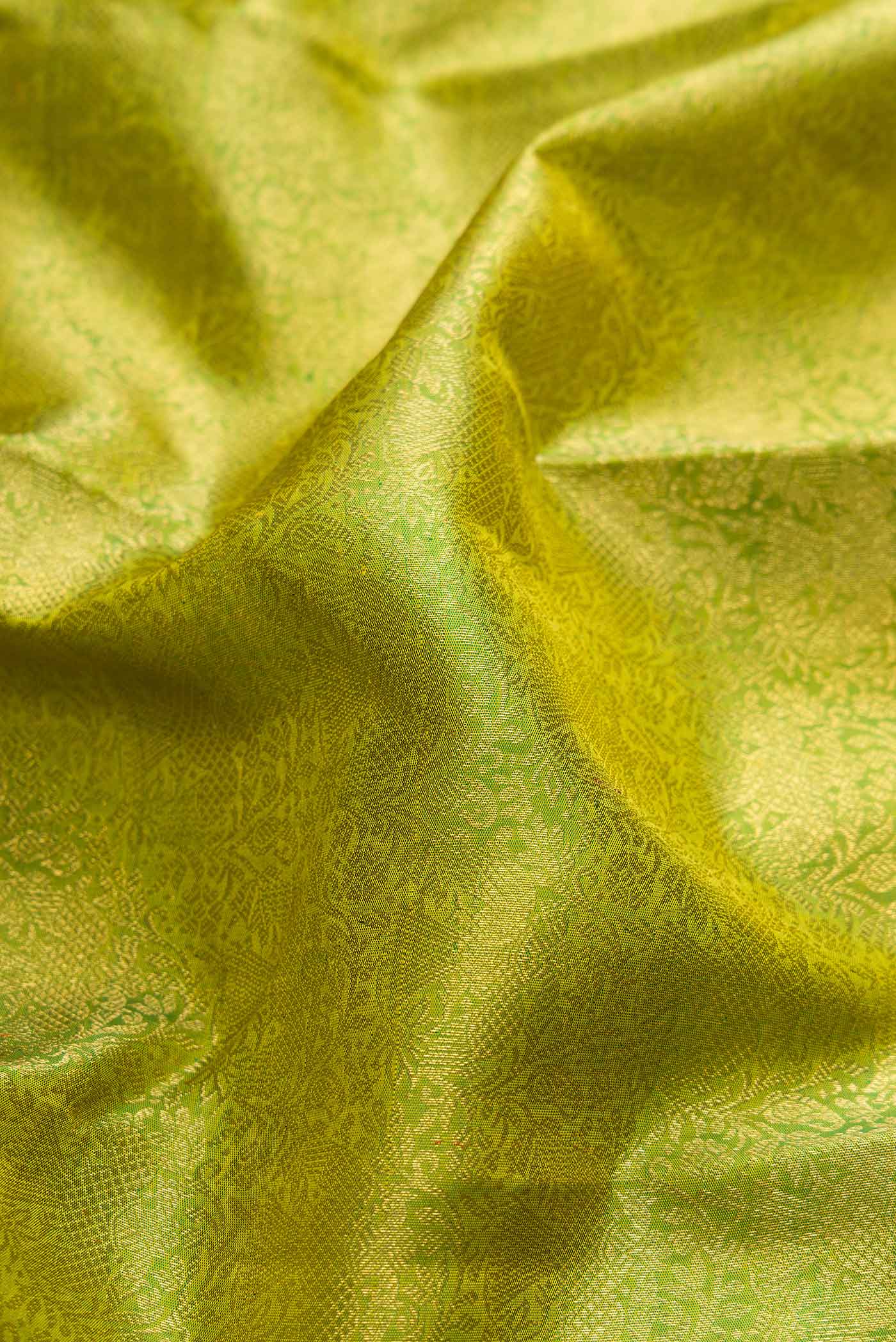 Close up of Pure Silk Pure Zari Green Dual Tone Kanchipuram Saree with Zari Brocade on the body and Zari Border displaying folds