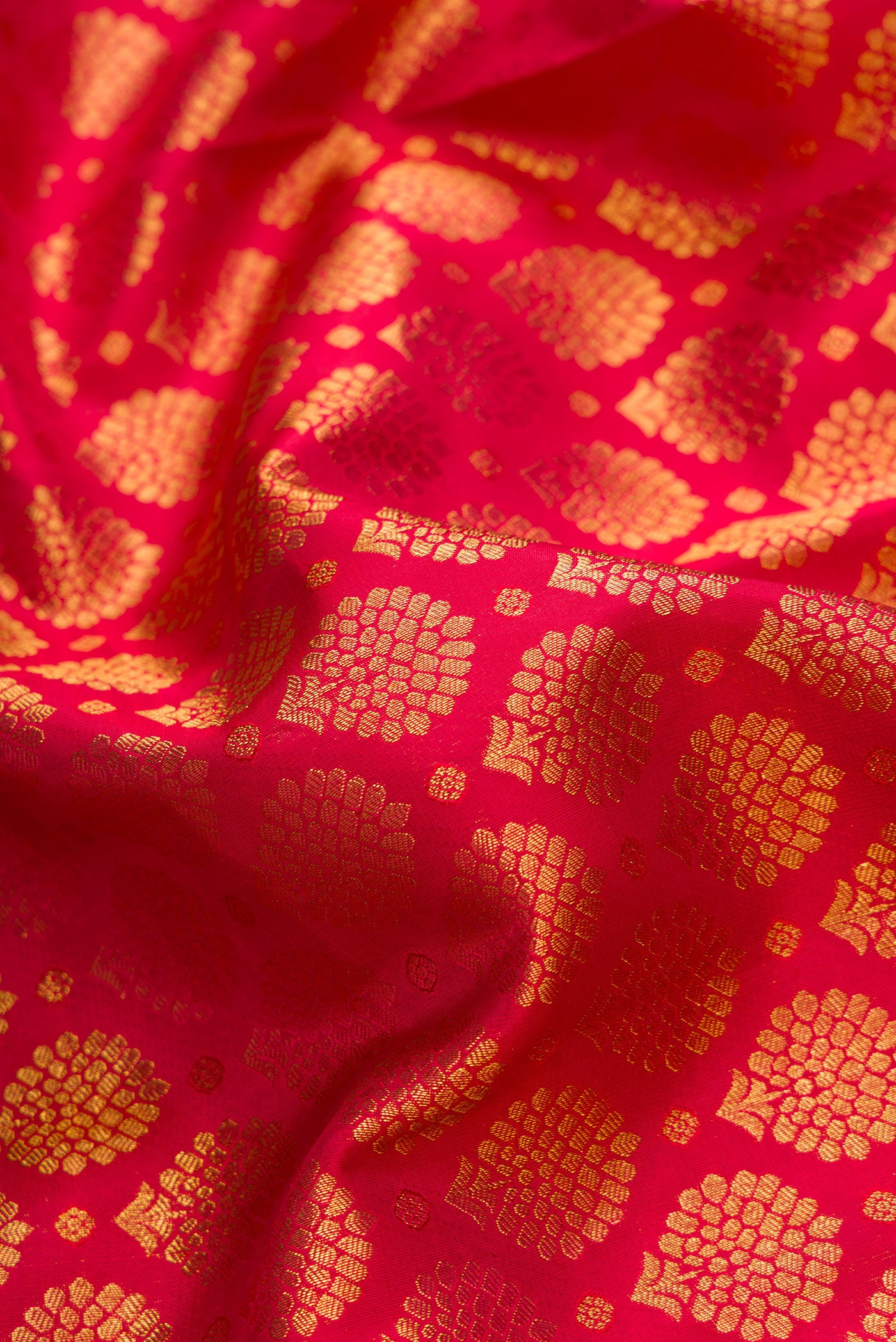 Close up of Red Dual Tone Kanchipuram Silk Saree with Zari Brocade on the body and Zari Border.  displaying folds
