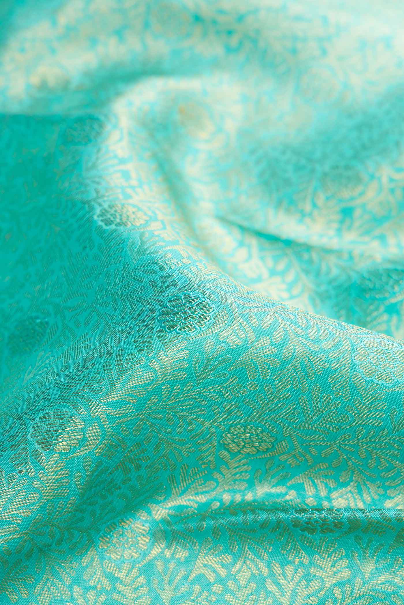 Close up of Sky Blue Dual Tone Kanchipuram Silk Saree with Zari Brocade on the body and Zari Border displaying folds