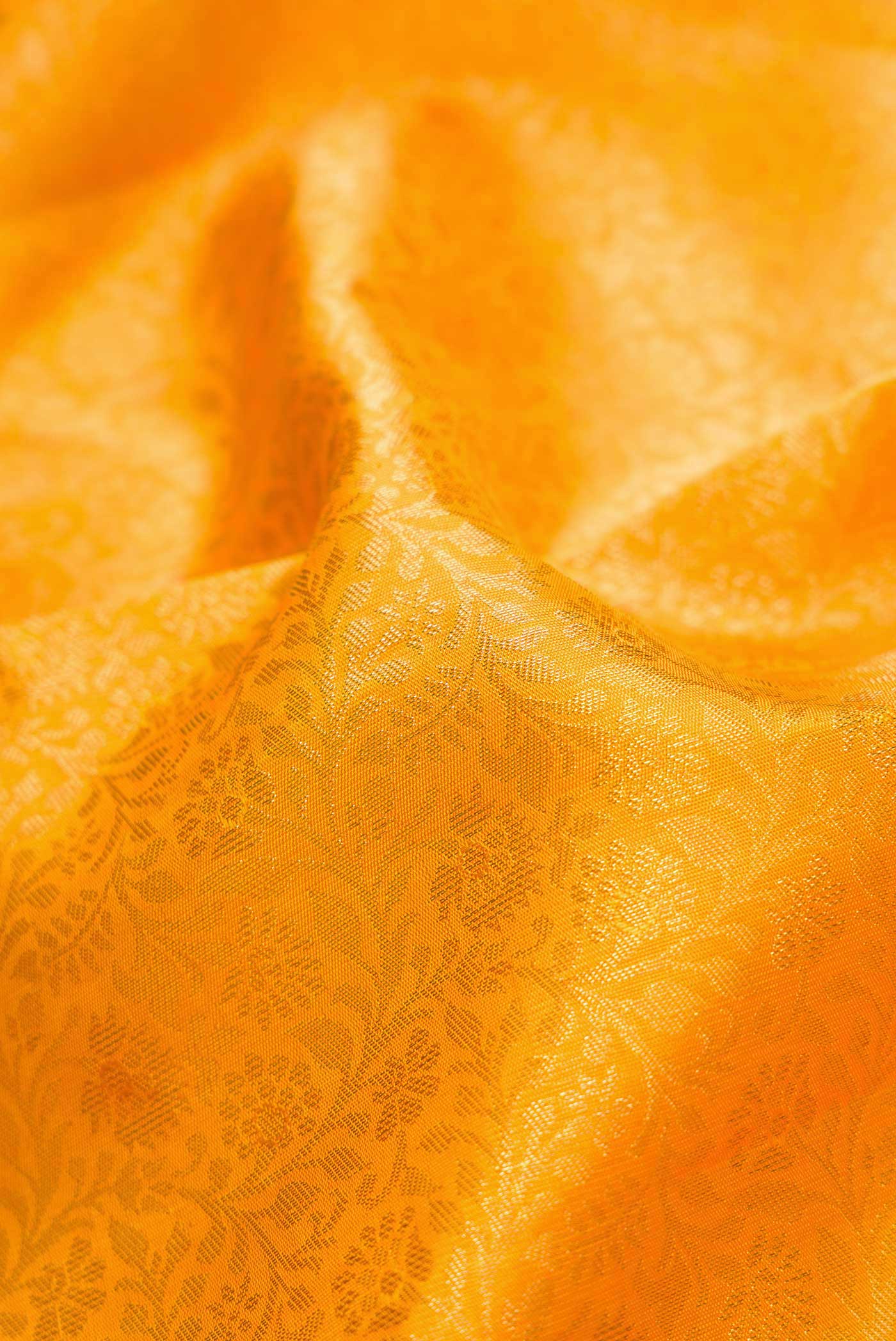 Close up of Pure Silk Pure Zari Mustard Dual Tone Kanchipuram Saree with Zari Brocade on the body and Zari Border displaying folds