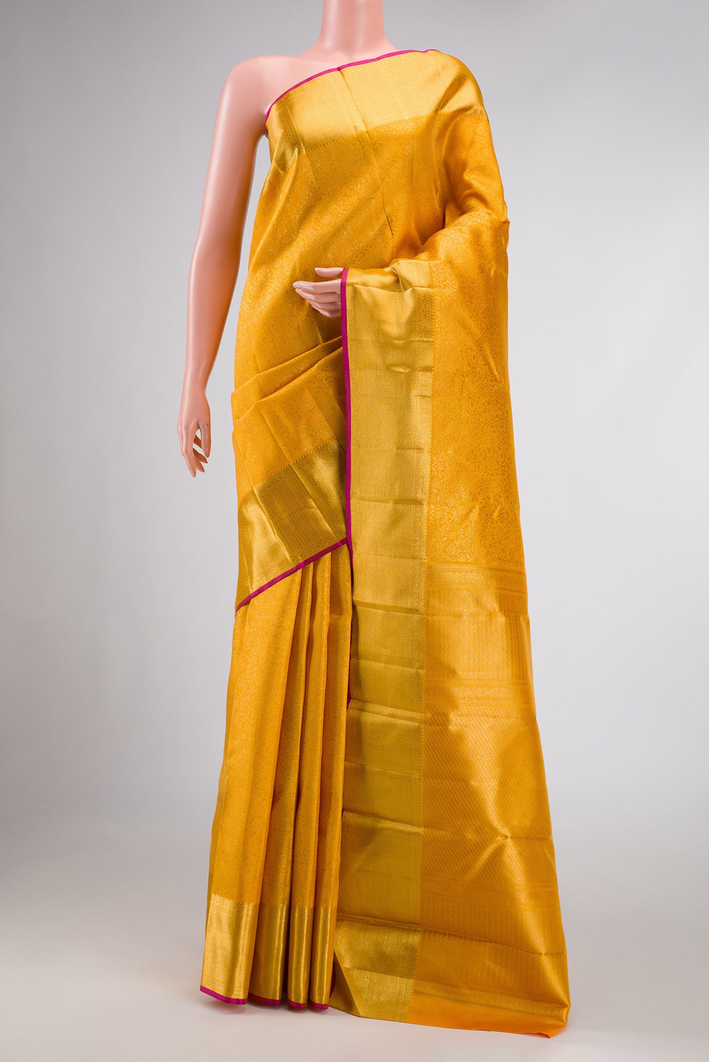 Pure Silk Pure Zari Mustard Dual Tone Kanchipuram Saree with Zari Brocade on the body and Zari Border displayed on a mannequin